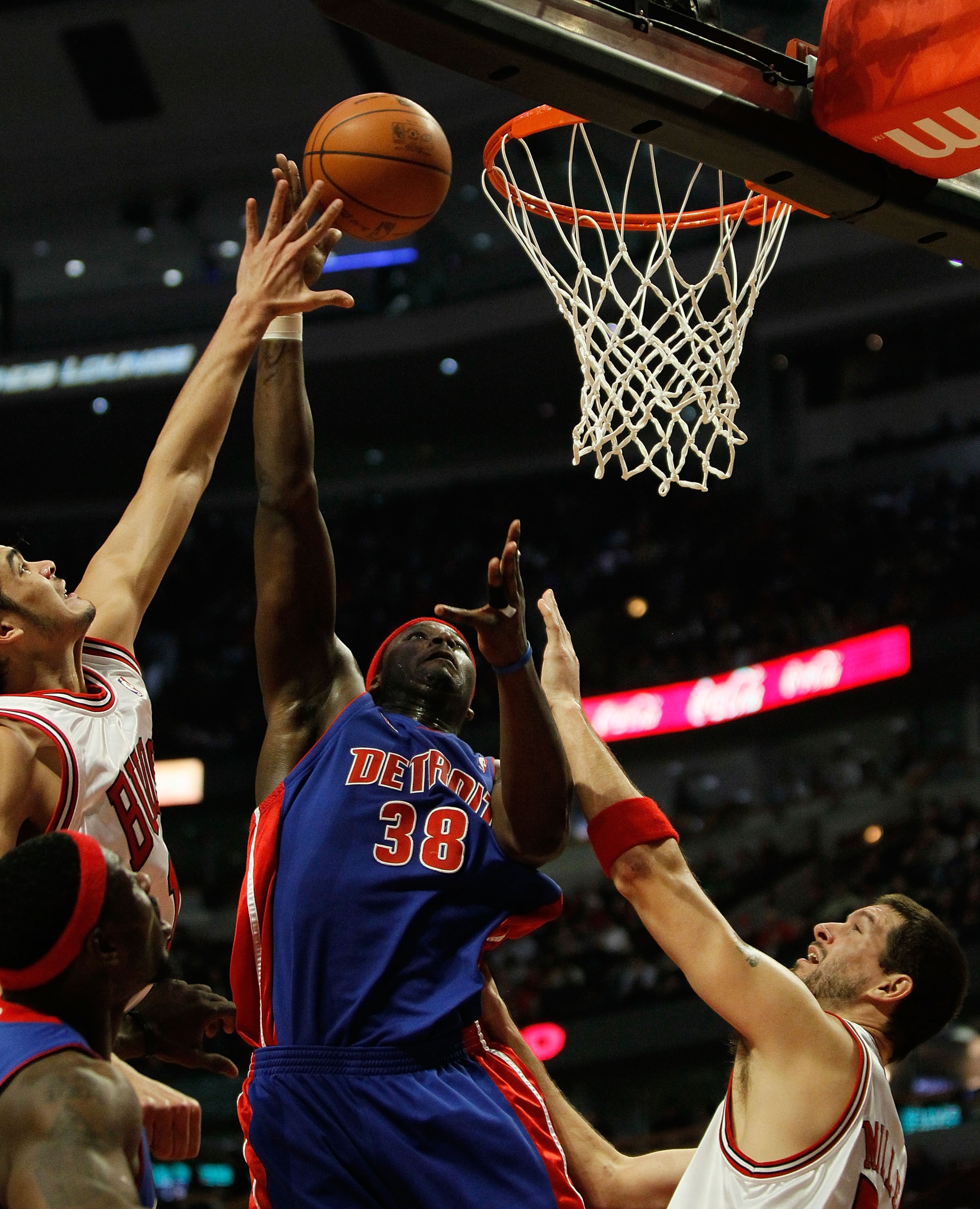 CHICAGO - DECEMBER 02: Kwame Brown #38 of the Detroit Pistons puts up a shot between Joakim Noah #13 (R) and Brad Miller #52 of the Chicago Bulls at the United Center on December 2, 2009 in Chicago, Illinois. NOTE TO USER: User expressly acknowledges and CHICAGO - DECEMBER 02: Kwame Brown #38 of the Detroit Pistons puts up a shot between Joakim Noah #13 (R) and Brad Miller #52 of the Chicago Bulls at the United Center on December 2, 2009 in Chicago, Illinois. NOTE TO USER: User expressly acknowledges and