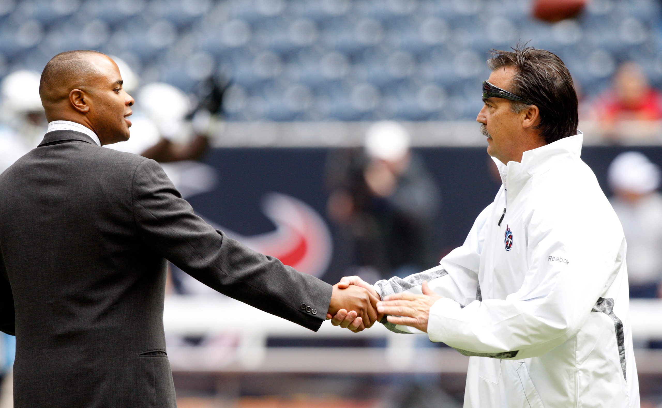 HOUSTON - NOVEMBER 28:  Rick Smith, general manager of the Houston Texans, left, talks with head coach Jeff Fisher before a football game at Reliant Stadium on November 28, 2010 in Houston, Texas.  (Photo by Bob Levey/Getty Images)
