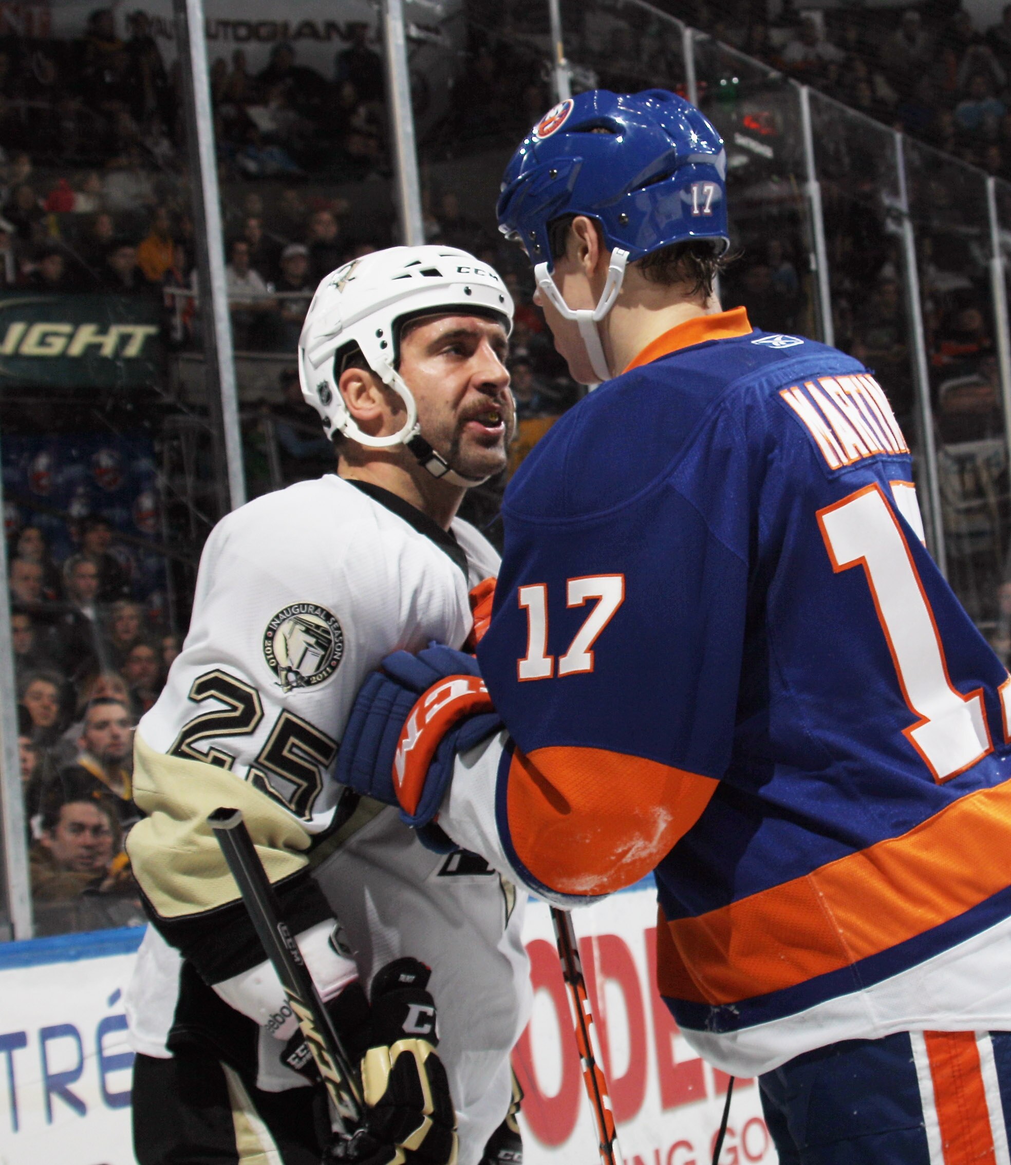 UNIONDALE, NY - DECEMBER 29:  Maxime Talbot #25 of the Pittsburgh Penguins skates against Matt Martin #17 of the New York Islanders at the Nassau Coliseum on December 29, 2010 in Uniondale, New York. The Islanders defeated the Penguins 2-1 in the shootout
