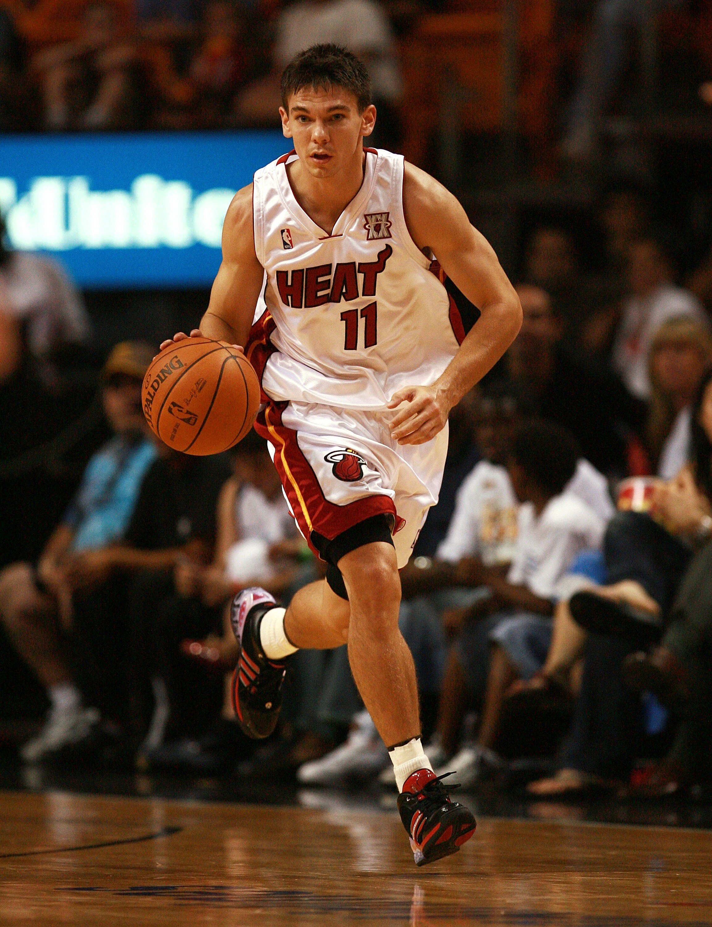 MIAMI - OCTOBER 23:  Chris Quinn #11 of the Miami Heat brings the ball up court against the San Antonio Spurs at American Airlines Arena on October 23, 2007 in Miami, Florida. The Spurs defeated the Heat 104-87. NOTE TO USER: User expressly acknowledges a