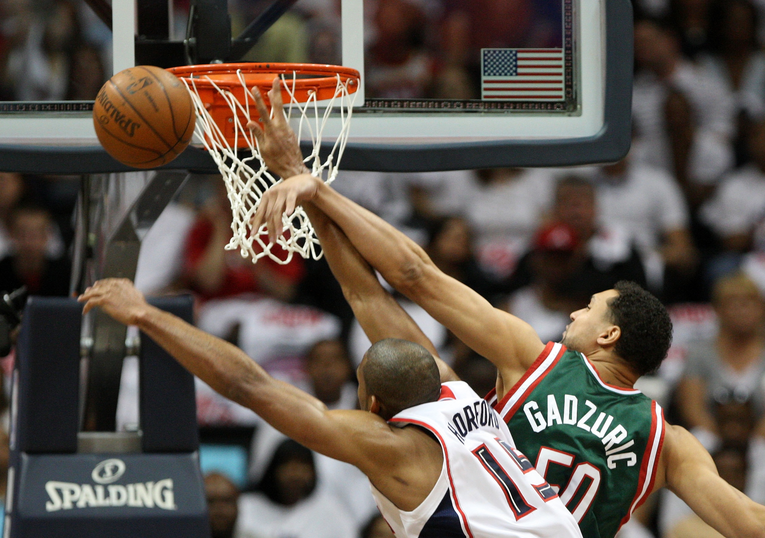 ATLANTA - MAY 2: Center Dan Gadzuric #50 of the Milwaukee Bucks fouls center Al Horford #15 of the Atlanta Hawks during Horford's shot attempt during Game Seven of the Eastern Conference Quarterfinals between the Milwaukee Bucks and the Atlanta Hawks dur ATLANTA - MAY 2: Center Dan Gadzuric #50 of the Milwaukee Bucks fouls center Al Horford #15 of the Atlanta Hawks during Horford's shot attempt during Game Seven of the Eastern Conference Quarterfinals between the Milwaukee Bucks and the Atlanta Hawks dur