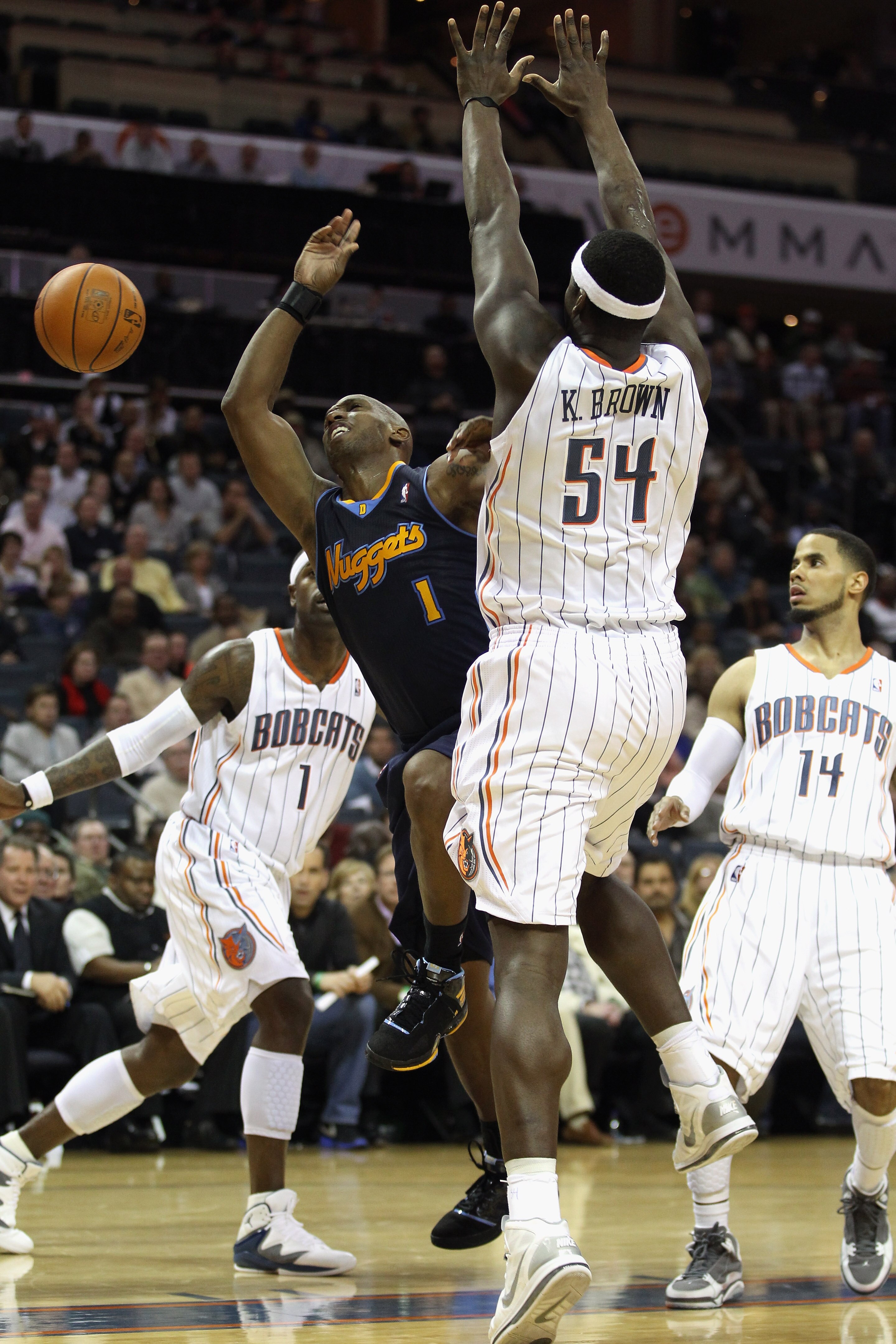 CHARLOTTE, NC - DECEMBER 07:  Chauncey Billups #1 of the Denver Nuggets is stopped by Kwame Brown #54 of the Charlotte Bobcats during their game at Time Warner Cable Arena on December 7, 2010 in Charlotte, North Carolina.  NOTE TO USER: User expressly ack