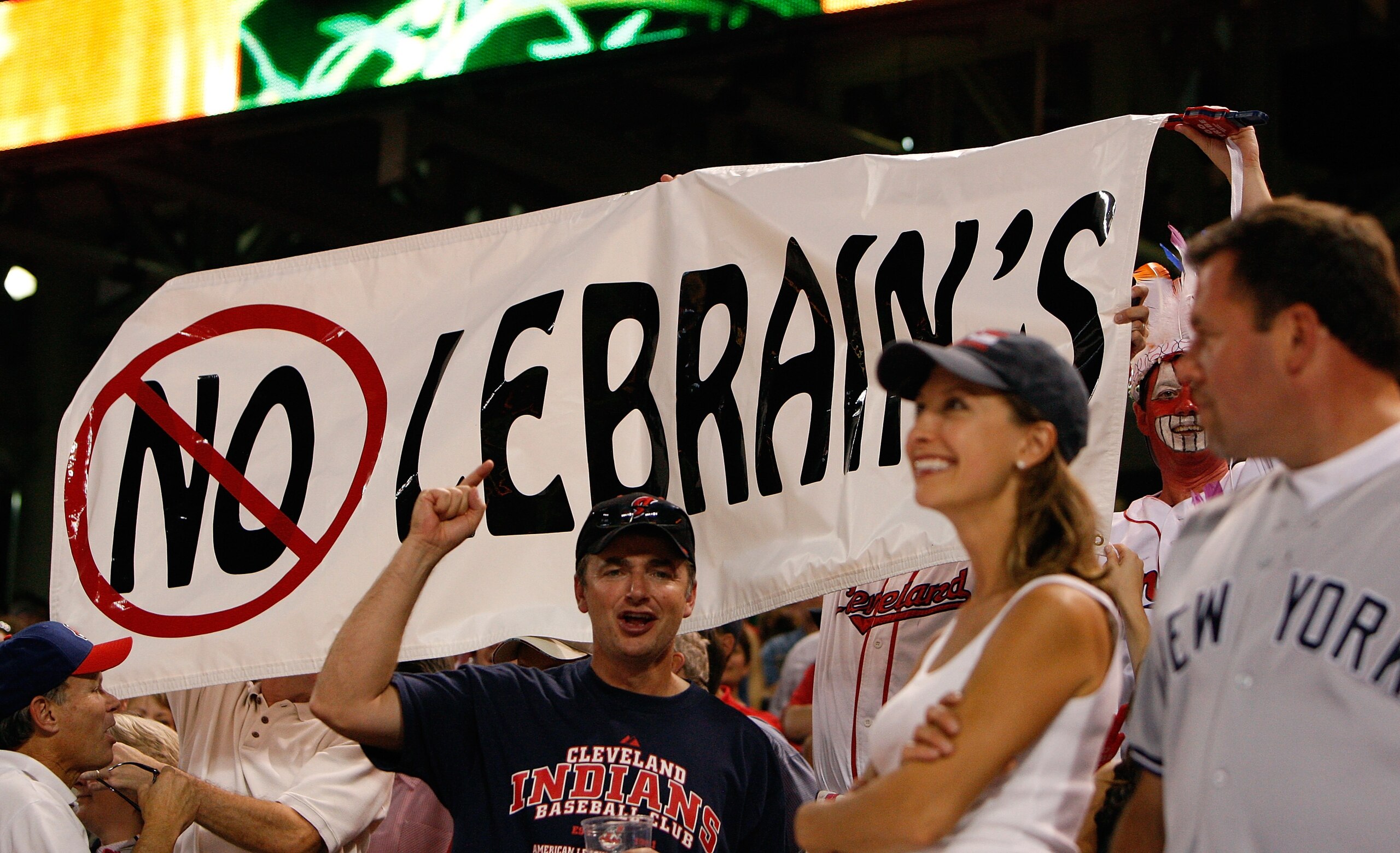 CLEVELAND - OCTOBER 05: Fans of the Cleveland Indians hold up a sign that reads 'No LeBrain's' in reaction to, NBA superstar LeBron James (of the Cleveland Cavaliers), support of the New York Yankees during Game Two of the American League Divisional Seri CLEVELAND - OCTOBER 05: Fans of the Cleveland Indians hold up a sign that reads 'No LeBrain's' in reaction to, NBA superstar LeBron James (of the Cleveland Cavaliers), support of the New York Yankees during Game Two of the American League Divisional Seri