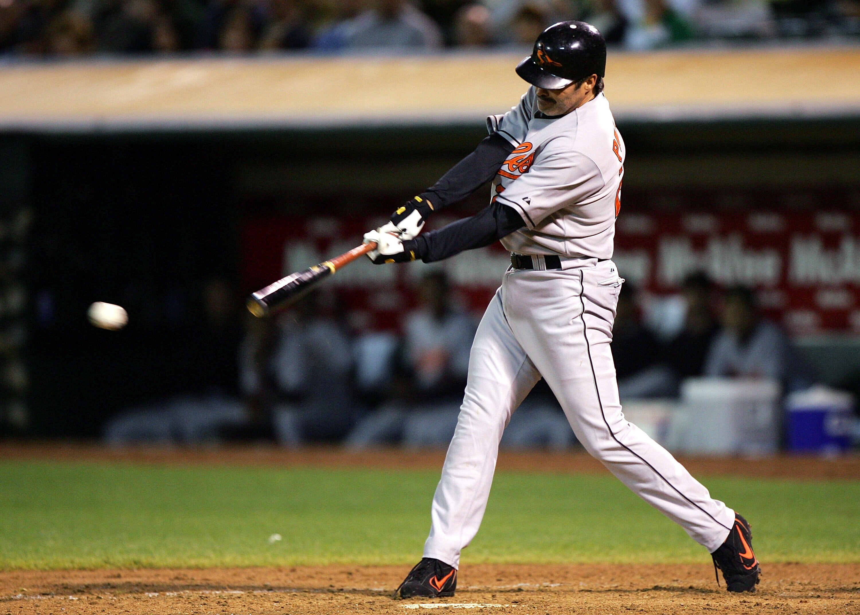 OAKLAND, CA - AUGUST 16: Rafael Palmeiro #25 of the Baltimore Orioles singles in the sixth inning against the Oakland Athletics during an MLB game at McAfee Coliseum on August 16, 2005 in Oakland, California.  (Photo by Jed Jacobsohn/Getty Images)