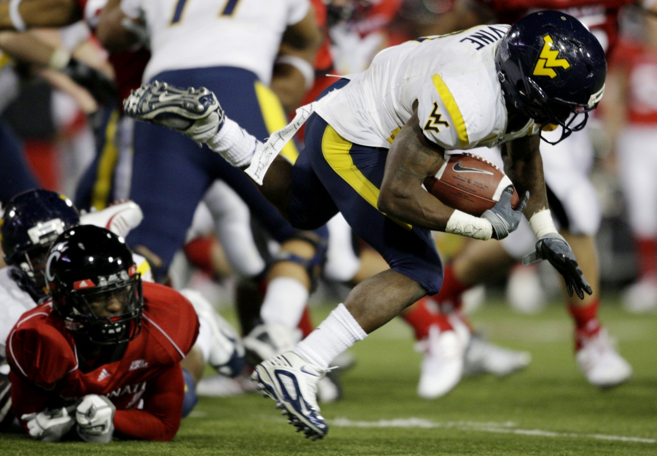 CINCINNATI - NOVEMBER 13:  Runningback Noel Devine #7 of the West Virginia Mountaineers is taken down in the third quarter of the game against the Cincinnati Bearcats in at Nippert Stadium on November 13, 2009 in Cincinnati, Ohio.  (Photo by Andy Lyons/Ge
