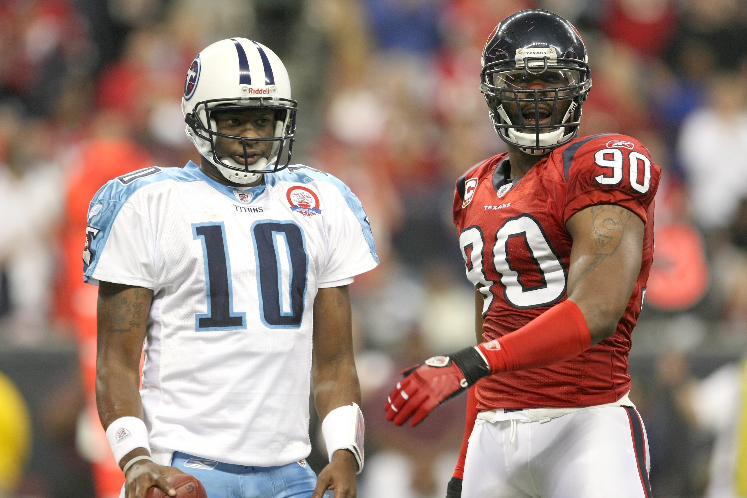 HOUSTON - NOVEMBER 23:  Quarterback Vince Young #10 of the Tennessee Titans and defensive end Mario Williams #90 of the Houston Texans on the field on November 23, 2009  at Reliant Stadium in Houston, Texas.  The Titans won 20-17  (Photo by Stephen Dunn/G