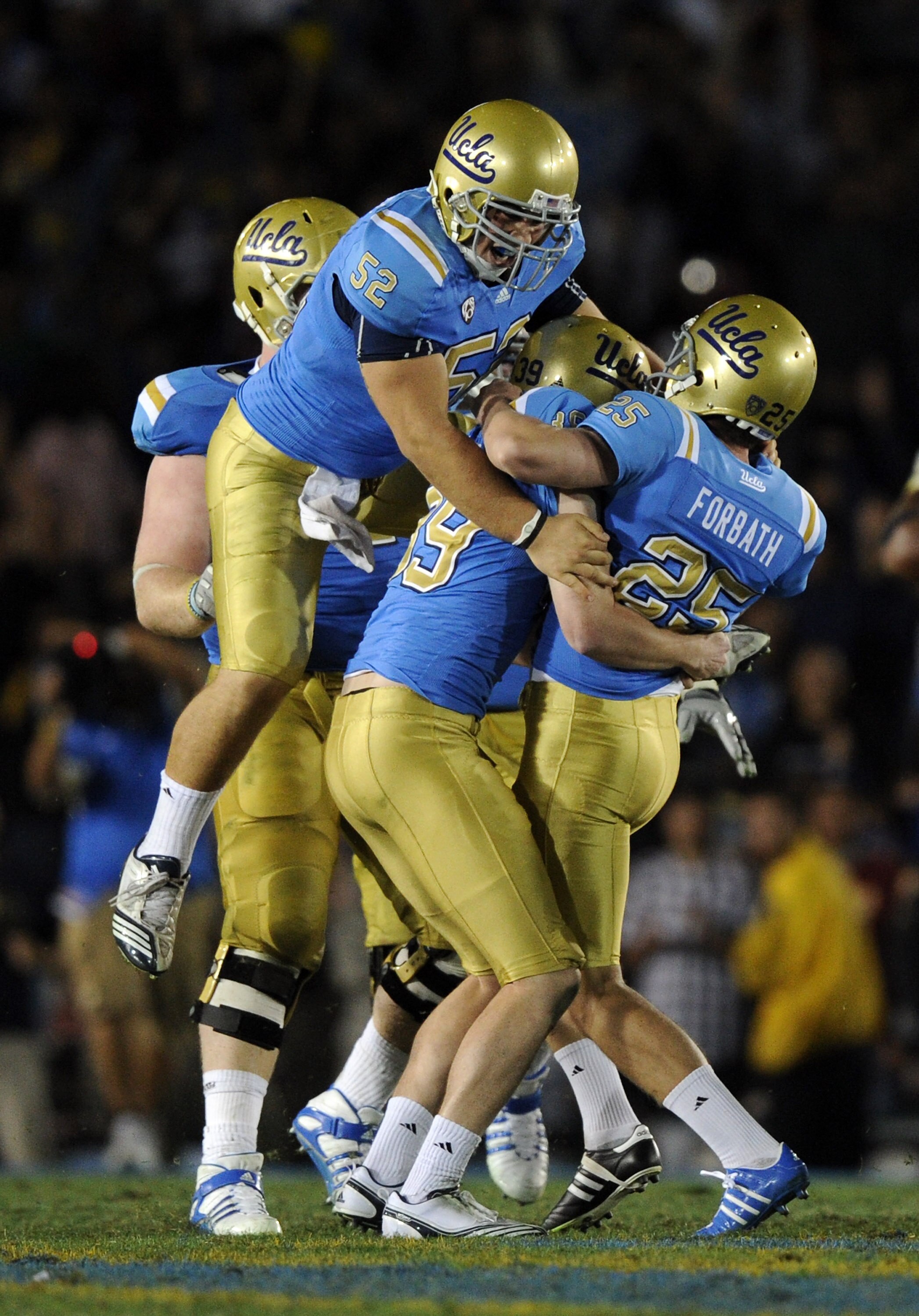 PASADENA, CA - NOVEMBER 06:  Kai Forbath #25 of the UCLA Bruins gets a hug from Danny Rees #39 and Christian Yount #52 in celebration of a last second field goal to win the game 17-14 over the Oregon State Beavers during the fourth quarter at the Rose Bow