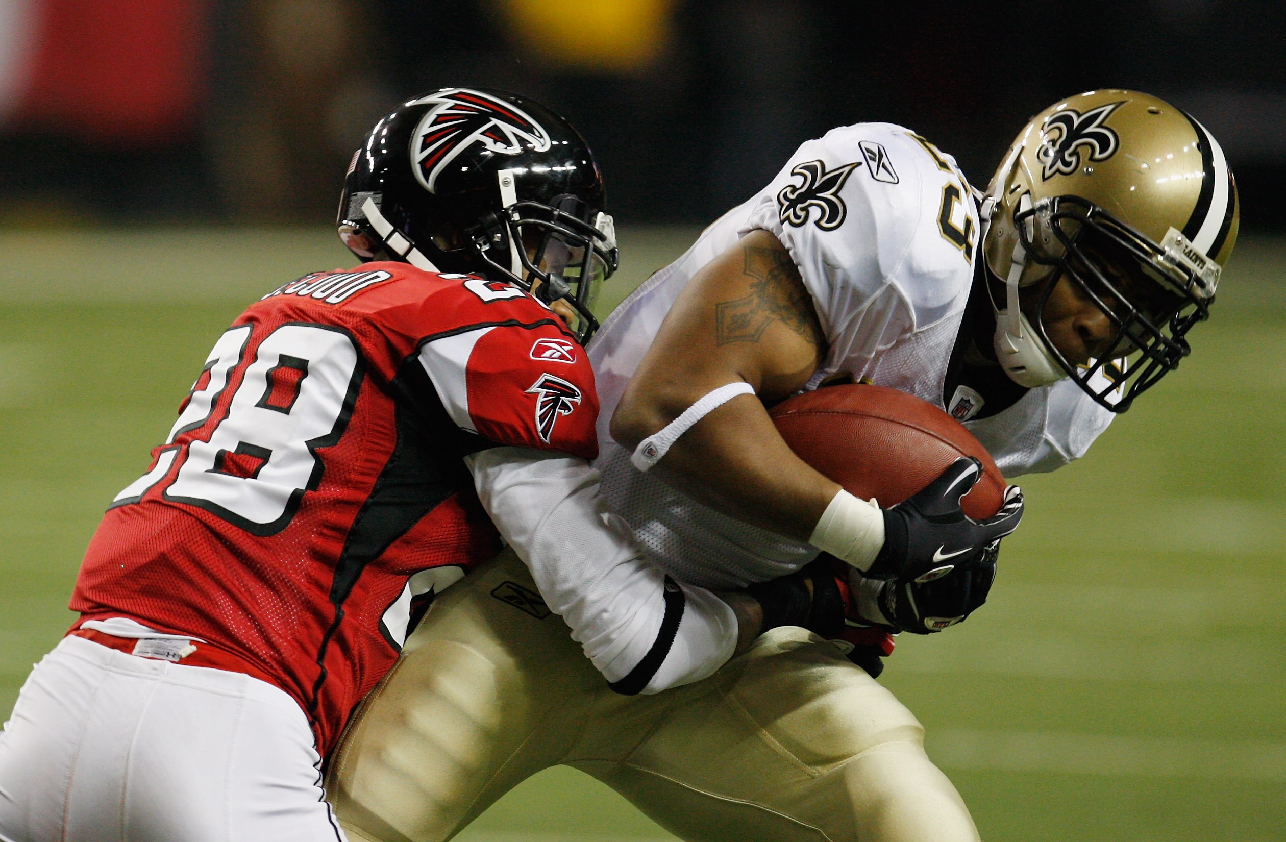 ATLANTA, GA - DECEMBER 27:  Pierre Thomas #23 of the New Orleans Saints fights off Atlanta Falcons defender Thomas DeCoud #28 in the first half during their game at the Georgia Dome on December 27, 2010 in Atlanta, Georgia.  (Photo by Scott Halleran/Getty