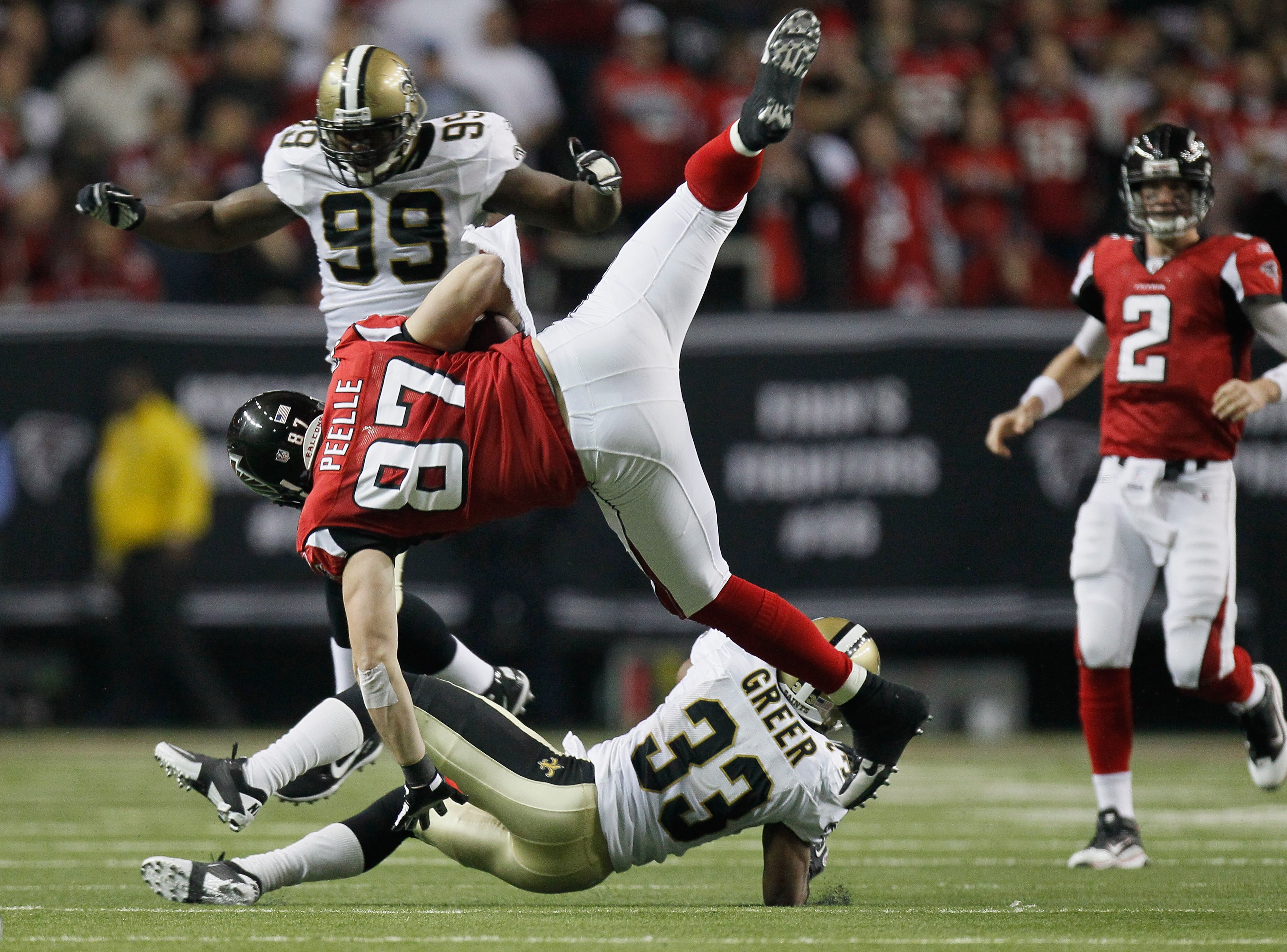 ATLANTA, GA - DECEMBER 27:  Justin Peelle #87 of the Atlanta Falcons goes up and over the tackle of Jabari Greer #33 of the New Orleans Saints during their game at the Georgia Dome on December 27, 2010 in Atlanta, Georgia.  (Photo by Kevin C. Cox/Getty Im