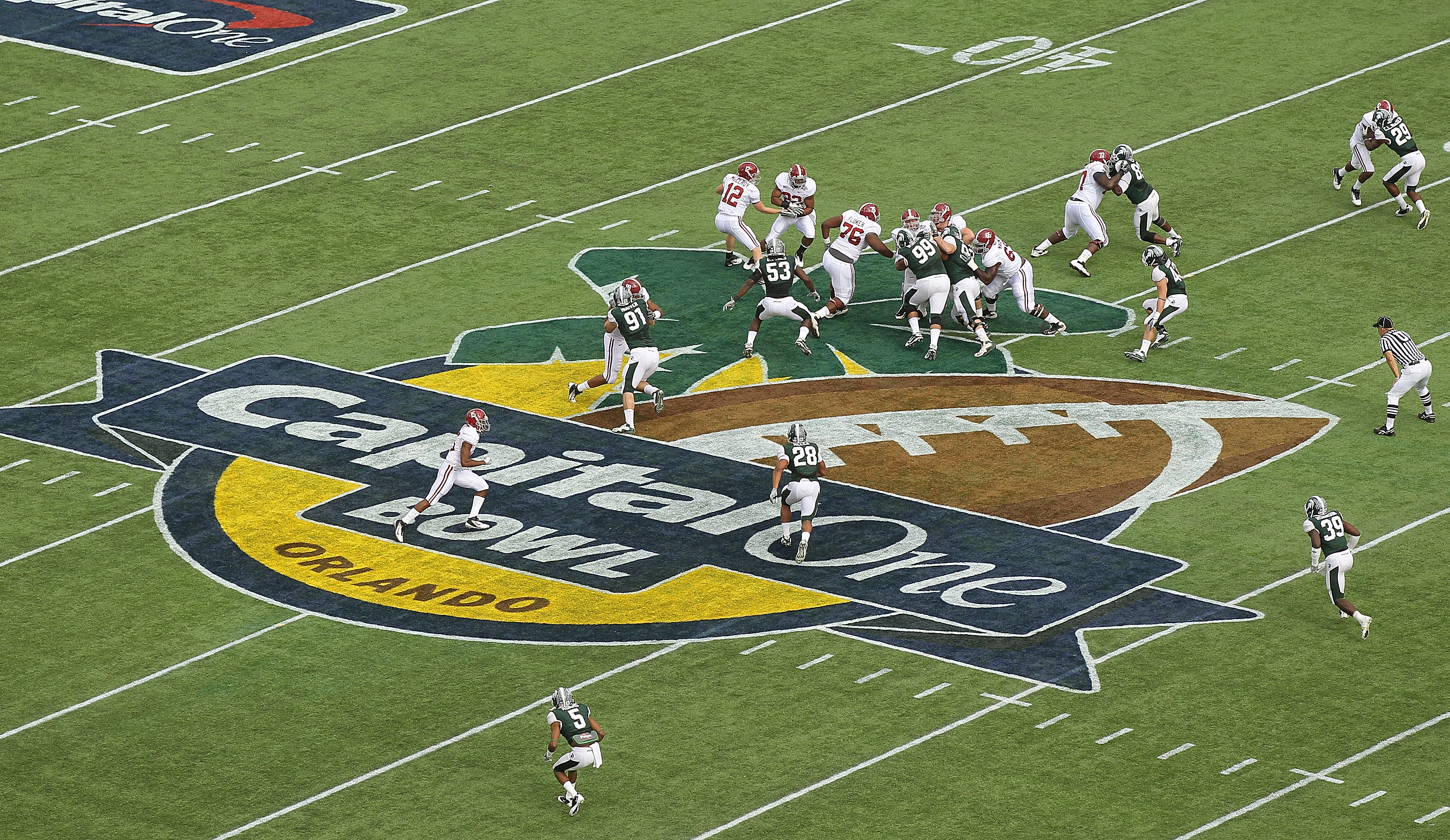 ORLANDO, FL - JANUARY 01:  Greg McElroy #12 of the Alabama Crimson Tide hands the ball off to Mark Ingram #22 during the Capitol One Bowl against the Michigan State Spartans at the Florida Citrus Bowl on January 1, 2011 in Orlando, Florida.  (Photo by Mik