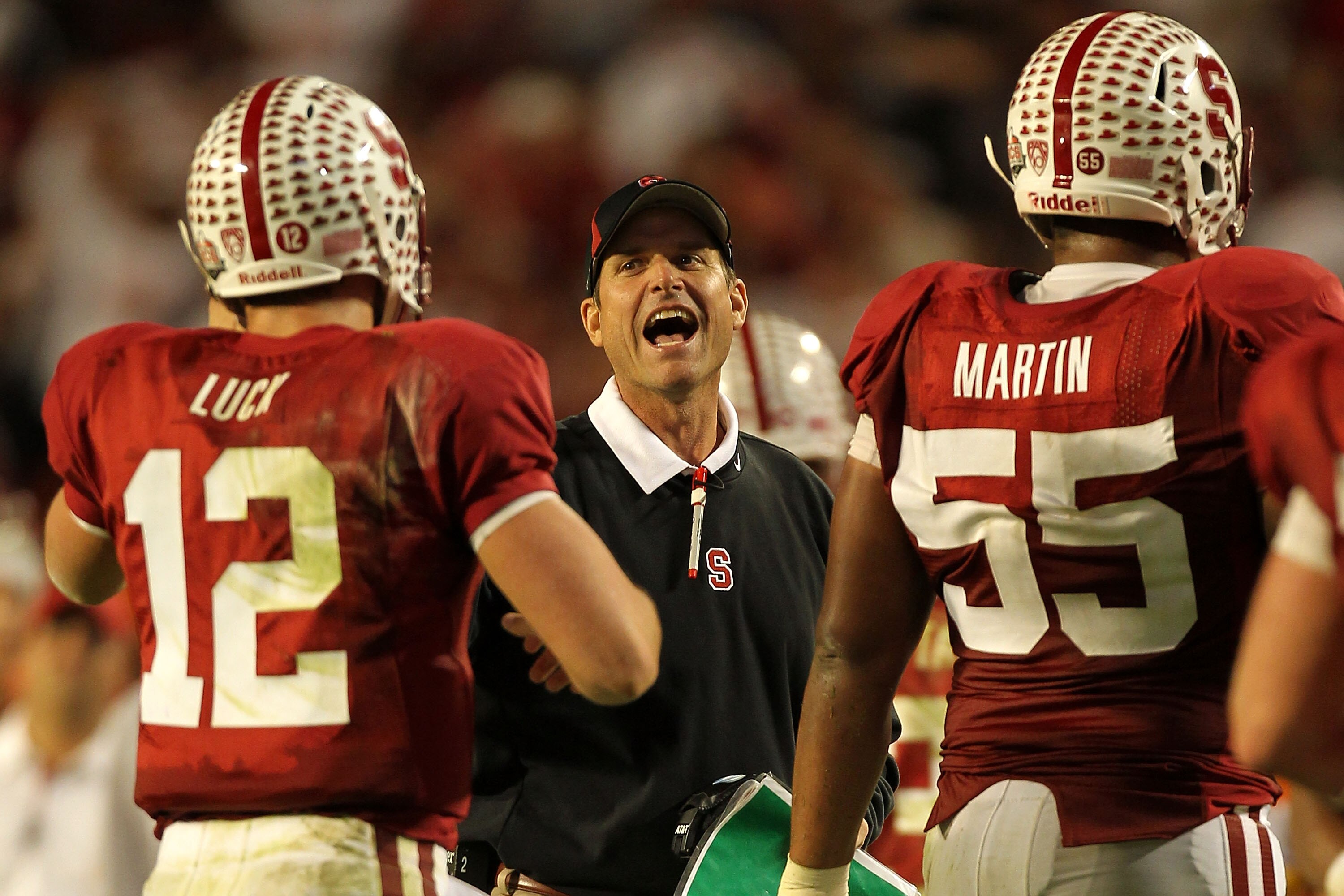 MIAMI, FL - JANUARY 03: Head coach Jim Harbaugh of the Stanford Cardinal celebrates a play with Andrew Luck #12 against the Virginia Tech Hokies during the 2011 Discover Orange Bowl at Sun Life Stadium on January 3, 2011 in Miami, Florida. Stanford won 40
