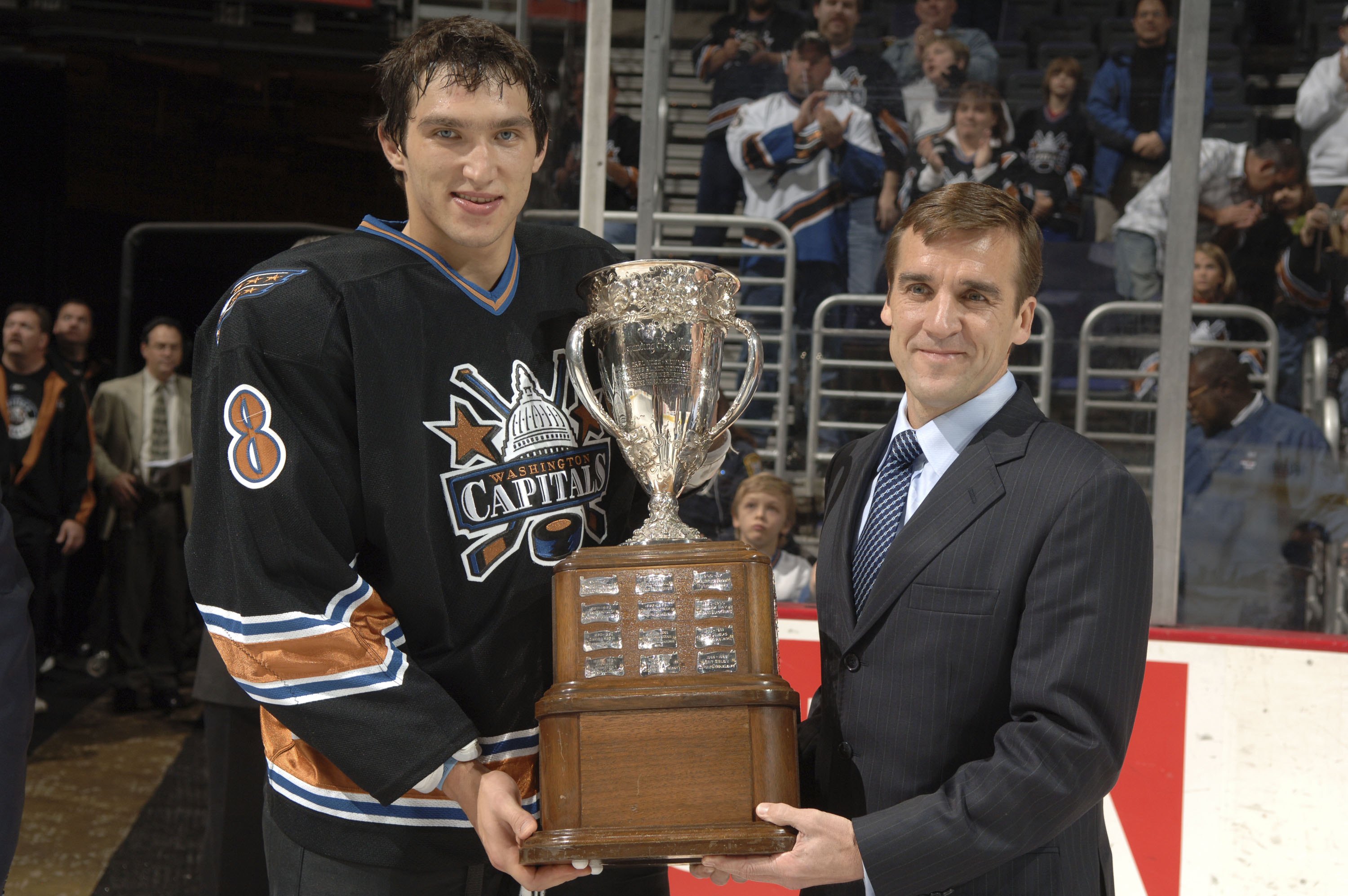 WASHINGTON - OCTOBER 14:  Washington Capitals' Alex Ovechkin #8 receives the Calder Trophy from VP and General Manager of the Washington Capitals, George McPhee, before a hockey game against the Atlanta Thrashers at the Verizon Center October 14, 2006 in