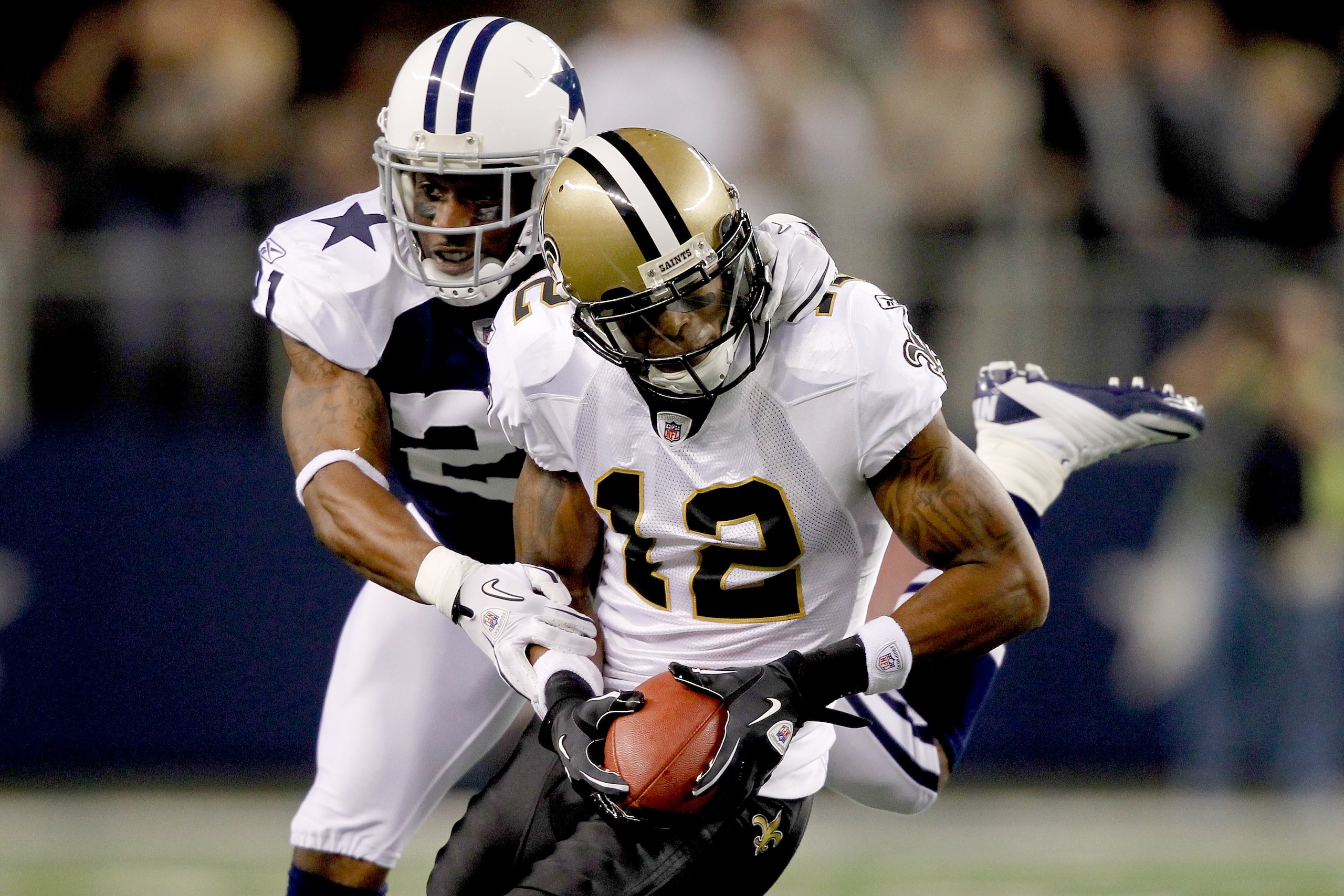 ARLINGTON, TX - NOVEMBER 25: Mike Jenkins #21 of the Dallas Cowboys tackles Marques Colston #12 of the New Orleans Saints at Cowboys Stadium on November 25, 2010 in Arlington, Texas.  (Photo by Matthew Stockman/Getty Images)