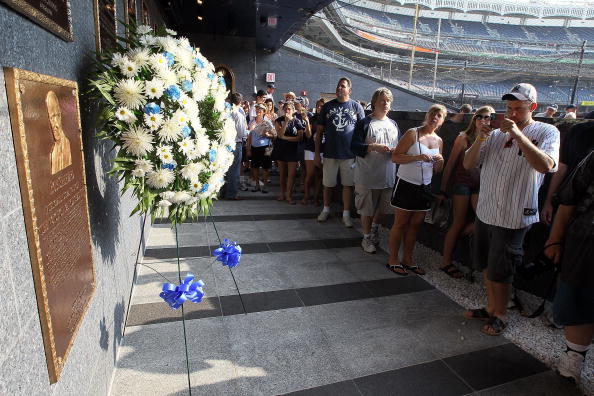 NEW YORK - JULY 16:  Fans of the New York Yankees line up to view the plaque of long time Yankee Stadium public address announcer Bob Sheppard in Monument Park prior to the game against the Tampa Bay Rays on July 16, 2010 in the Bronx borough of New York