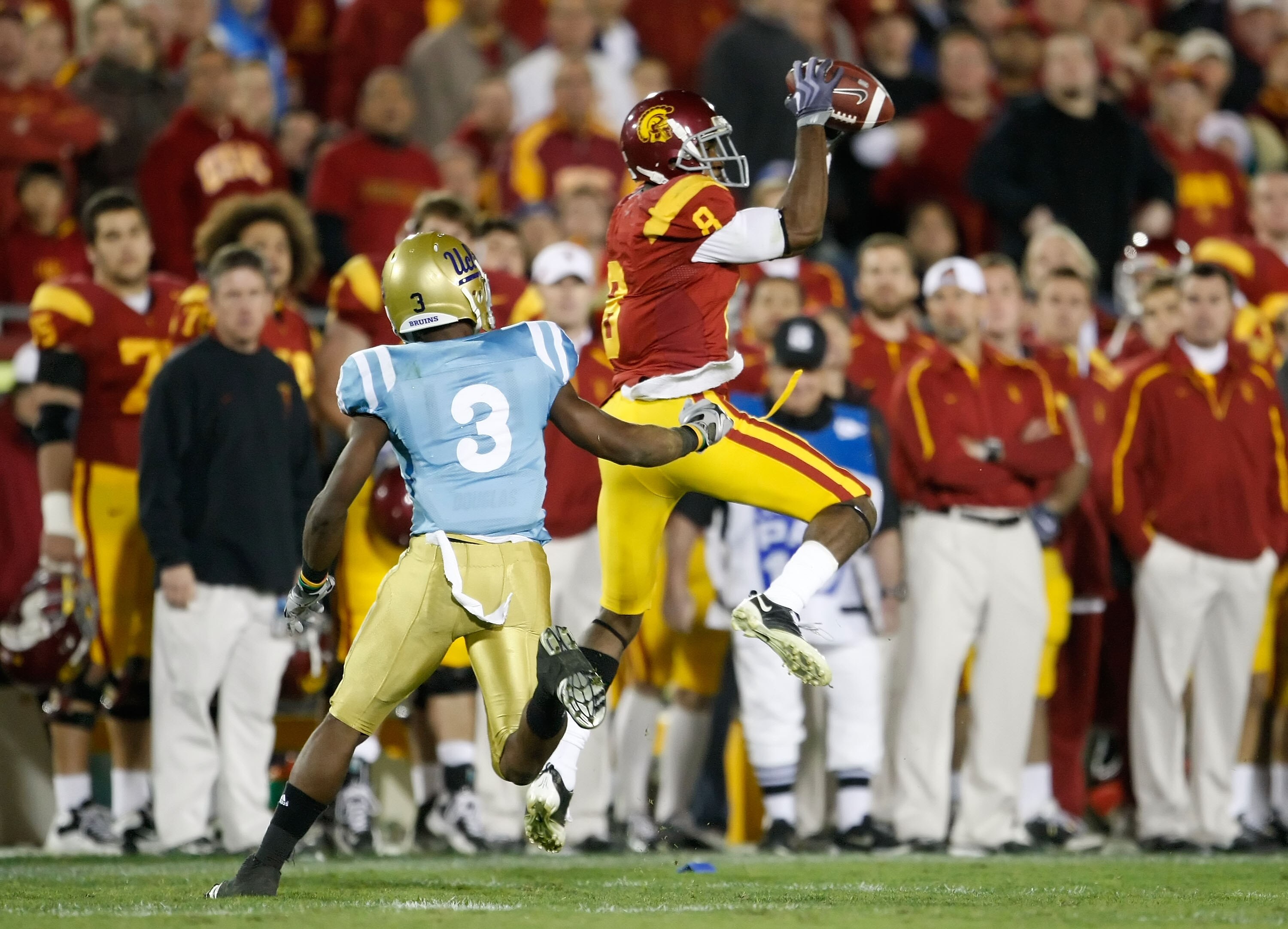 LOS ANGELES, CA - NOVEMBER 28:  Ronald Johnson #8 of the USC Trojans makes a catch while being pursued by Rahim Moore #3 of the UCLA Bruins in the second half at the Los Angeles Memorial Coliseum on November 28, 2009 in Los Angeles, California. USC defeat