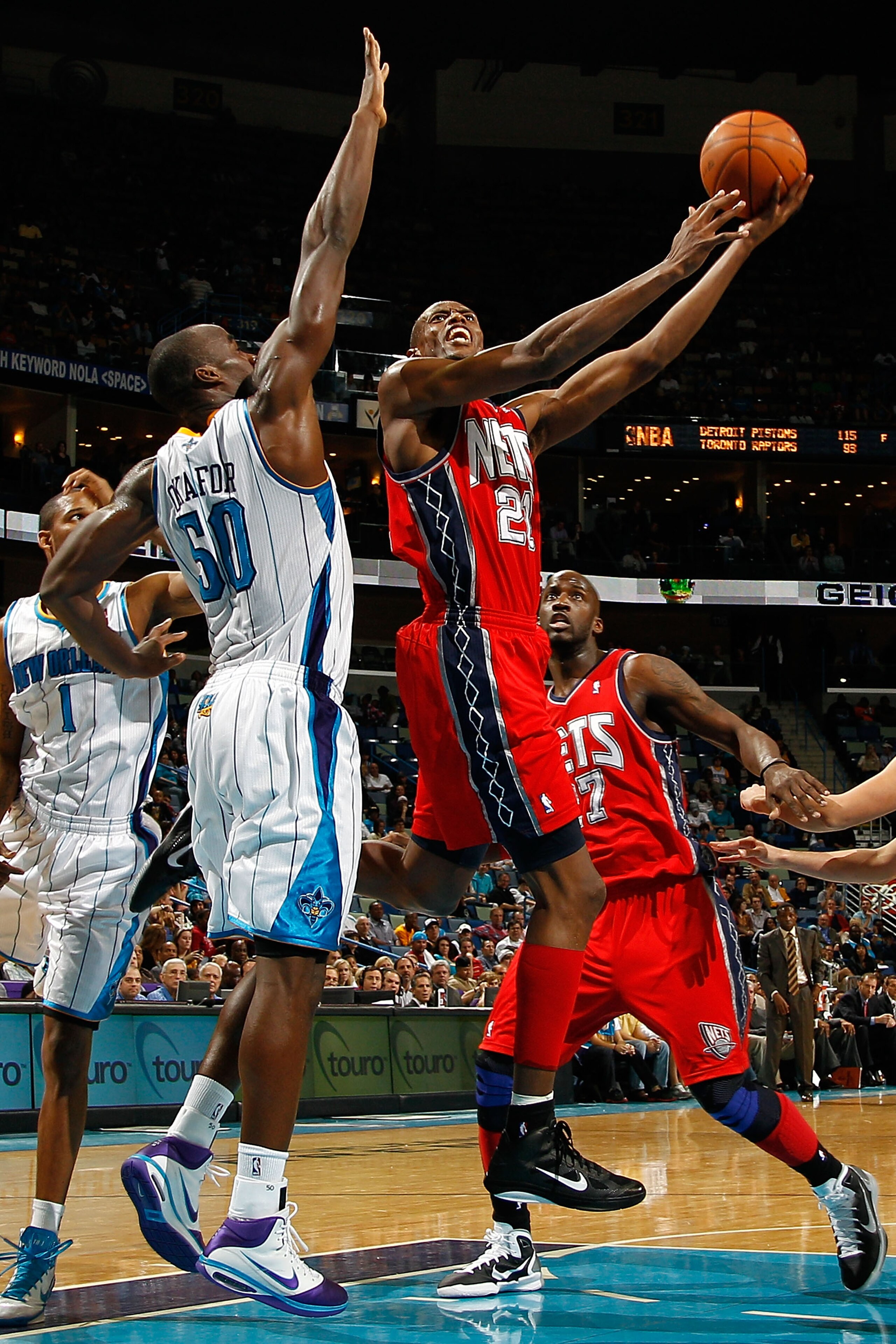 NEW ORLEANS, LA - DECEMBER 22:  Travis Outlaw #21 of the New Jersey Nets shoots the ball over Emeka Okafor #50 of the New Orleans Hornets at the New Orleans Arena on December 22, 2010 in New Orleans, Louisiana.    The Hornets defeated the Nets 105-91.   N