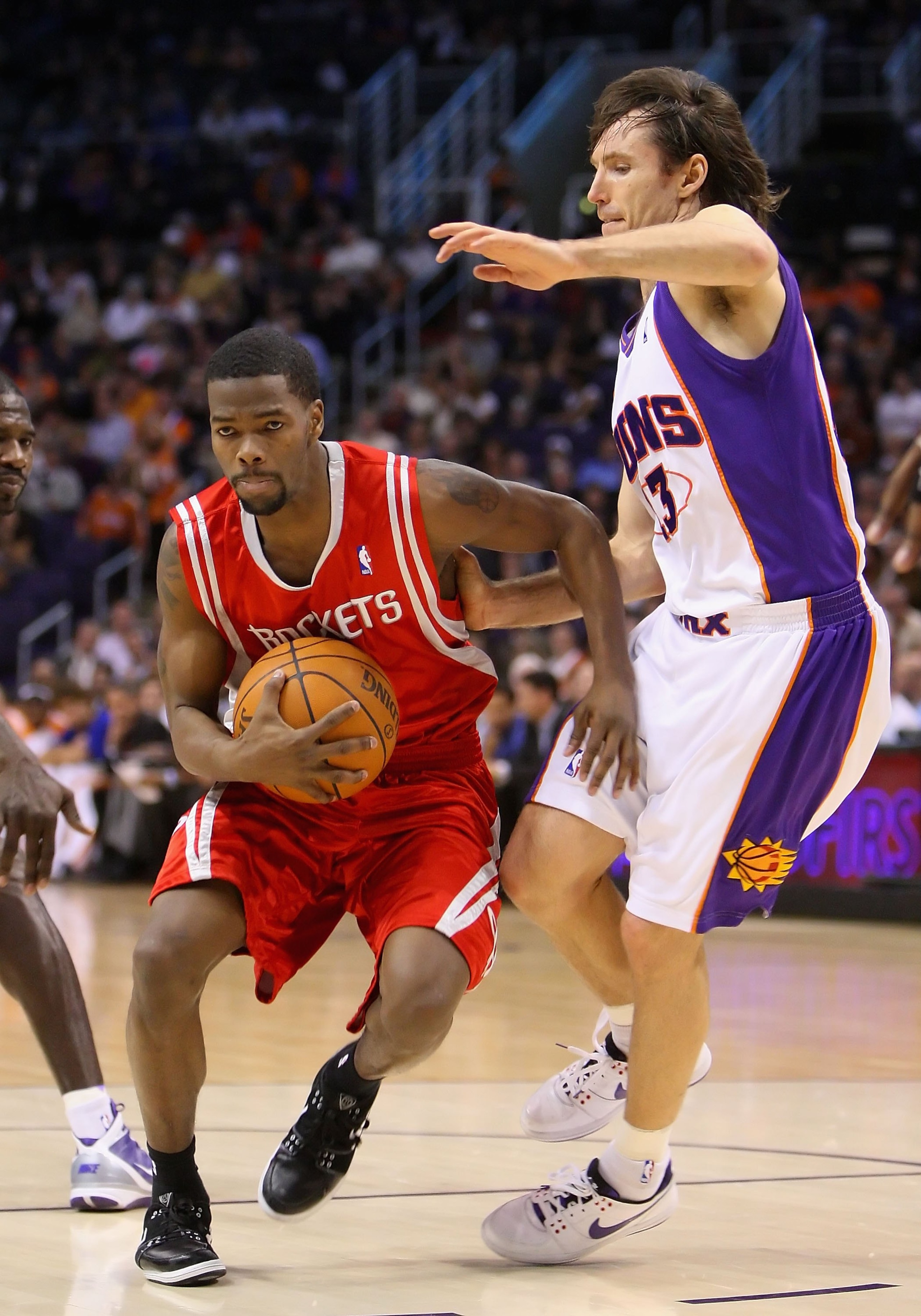 PHOENIX - JANUARY 06: Aaron Brooks #0 of the Houston Rockets drives the ball past Steve Nash #13 of the Phoenix Suns during the NBA game at US Airways Center on January 6, 2010 in Phoenix, Arizona. The Suns defeated the Rockets 118-110. NOTE TO USER: Us PHOENIX - JANUARY 06: Aaron Brooks #0 of the Houston Rockets drives the ball past Steve Nash #13 of the Phoenix Suns during the NBA game at US Airways Center on January 6, 2010 in Phoenix, Arizona. The Suns defeated the Rockets 118-110. NOTE TO USER: Us