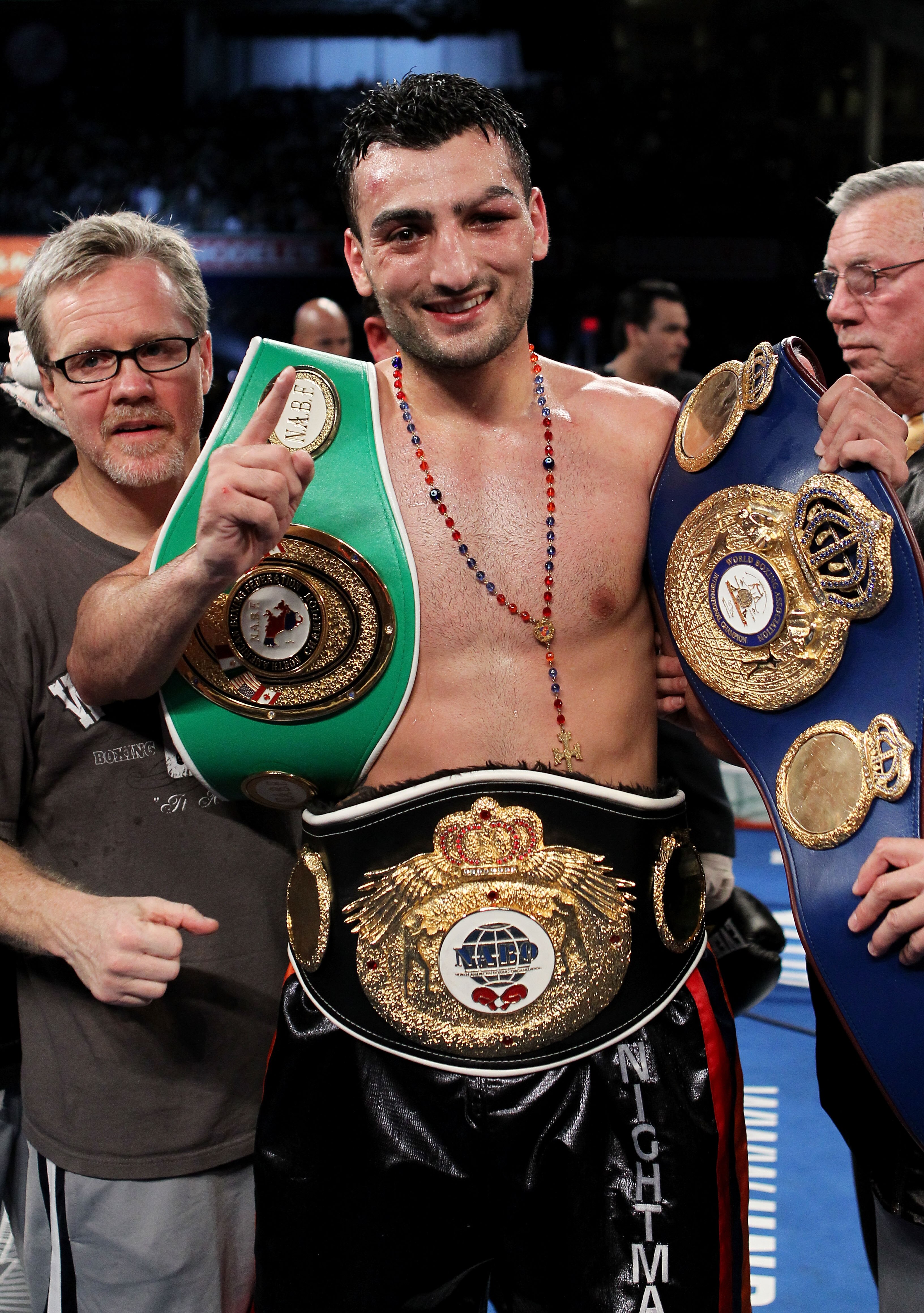NEW YORK - JUNE 05:  Vanes Martirosyan (C) celebrates defeating Joe Green with his trainer Freddie Roach (L) after the NABF & NABO super welterweight fight on June 5, 2010 at Yankee Stadium in the Bronx borough of New York City. Matirosyan wins by unanimo