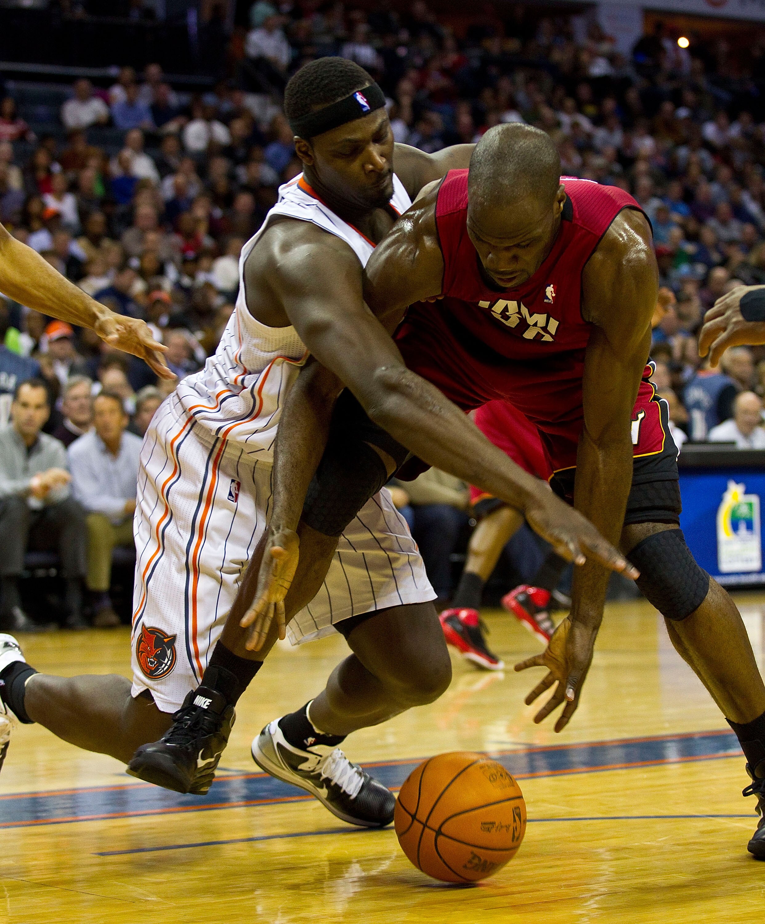 CHARLOTTE, NC - JANUARY 03: Kwame Brown #54 of the Charlotte Bobcats battles for a loose ball with Joel Anthony #50 of the Miami Heat at Time Warner Cable Arena on January 3, 2011 in Charlotte, North Carolina.  The Heat defeated the Bobcats 96-82.  (Photo