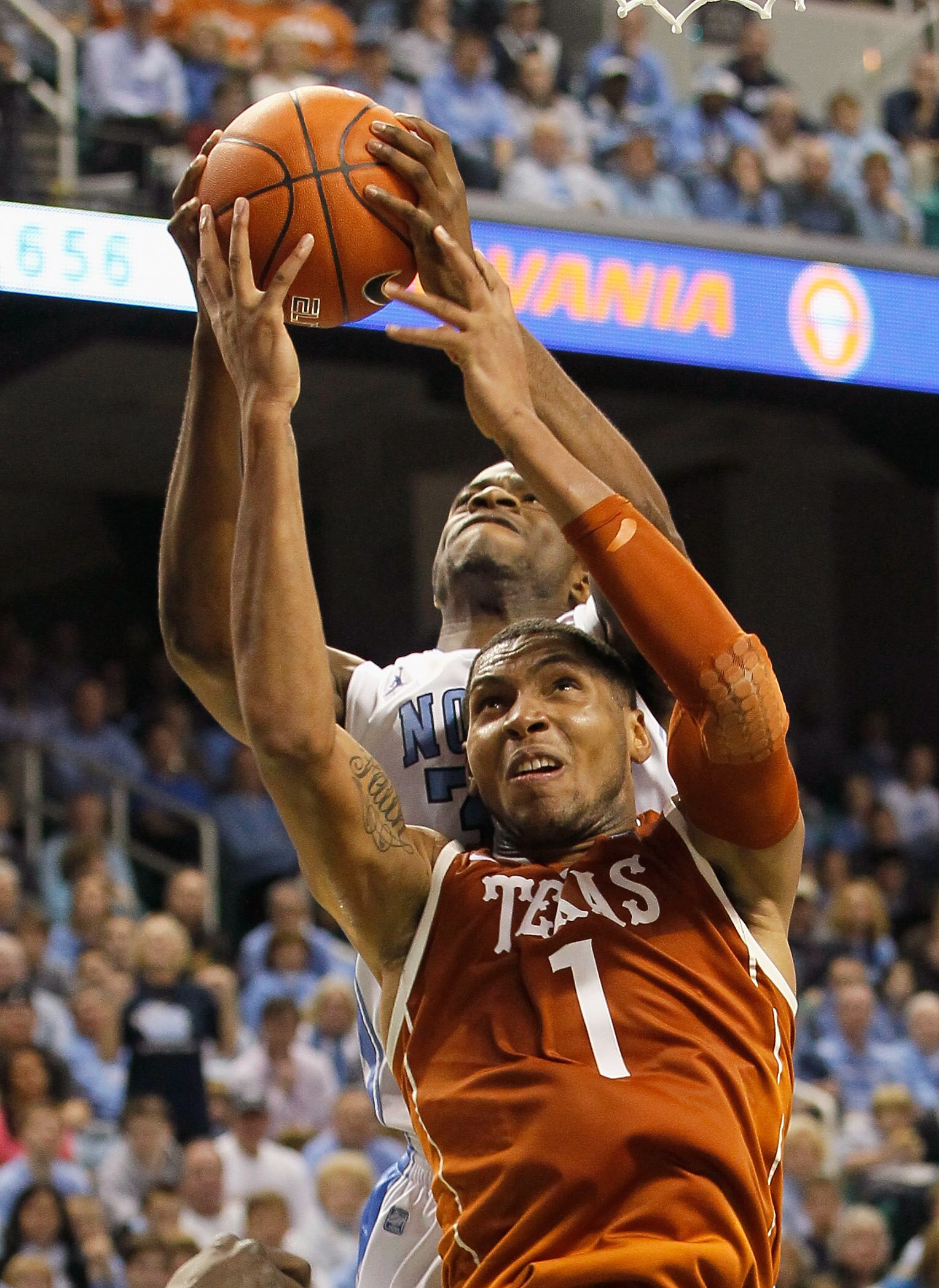 GREENSBORO, NC - DECEMBER 18:  Reggie Bullock #35 of the North Carolina Tar Heels grabs a rebound over Gary Johnson #1 of the Texas Longhorns at Greensboro Coliseum on December 18, 2010 in Greensboro, North Carolina.  (Photo by Kevin C. Cox/Getty Images)