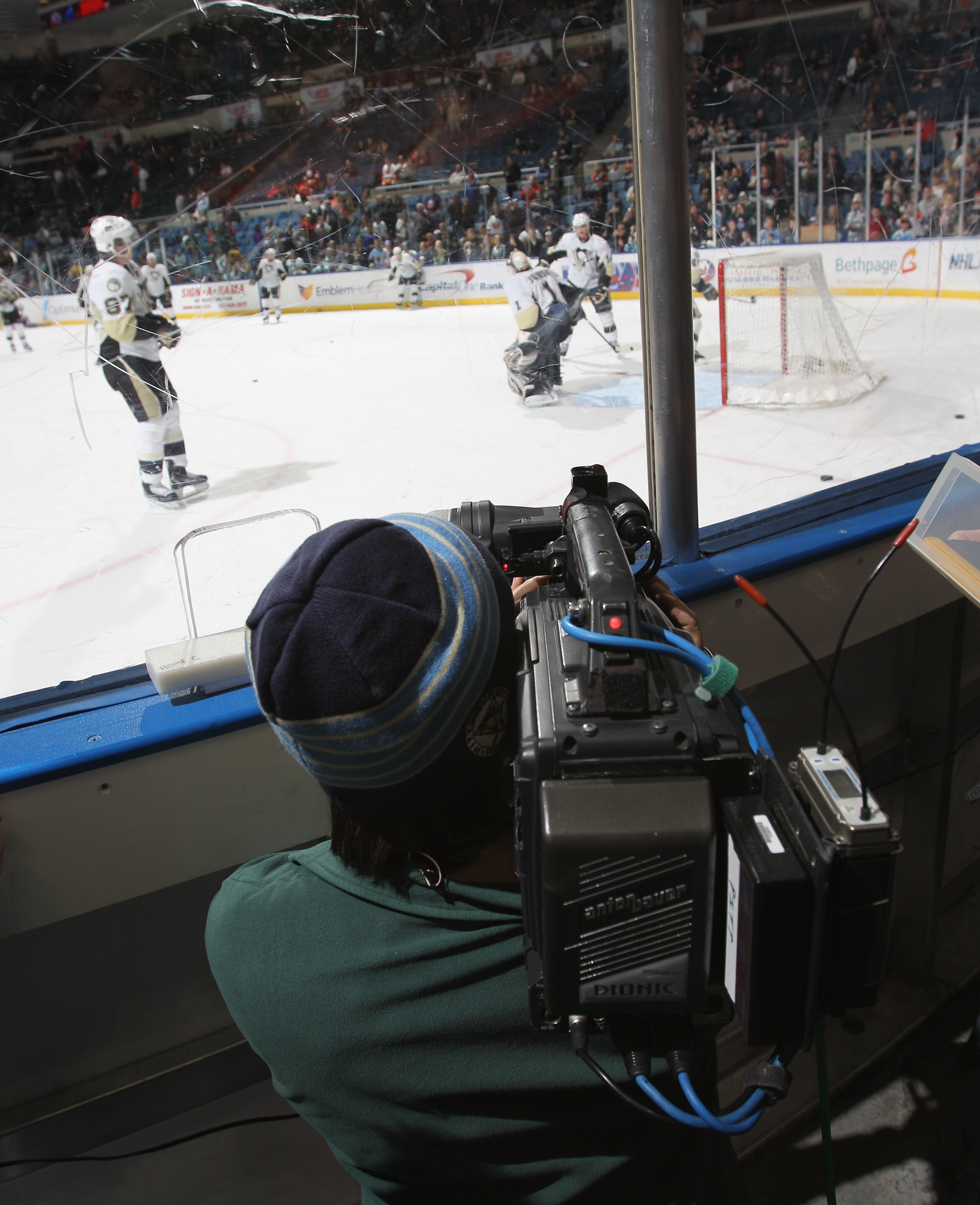UNIONDALE, NY - DECEMBER 29: A videographer for HBO's 24/7 series shoots warm ups prior to the game between the New York Islanders and the Pittsburgh Penguins at the Nassau Coliseum on December 29, 2010 in Uniondale, New York. (Photo by Bruce Bennett/Gett