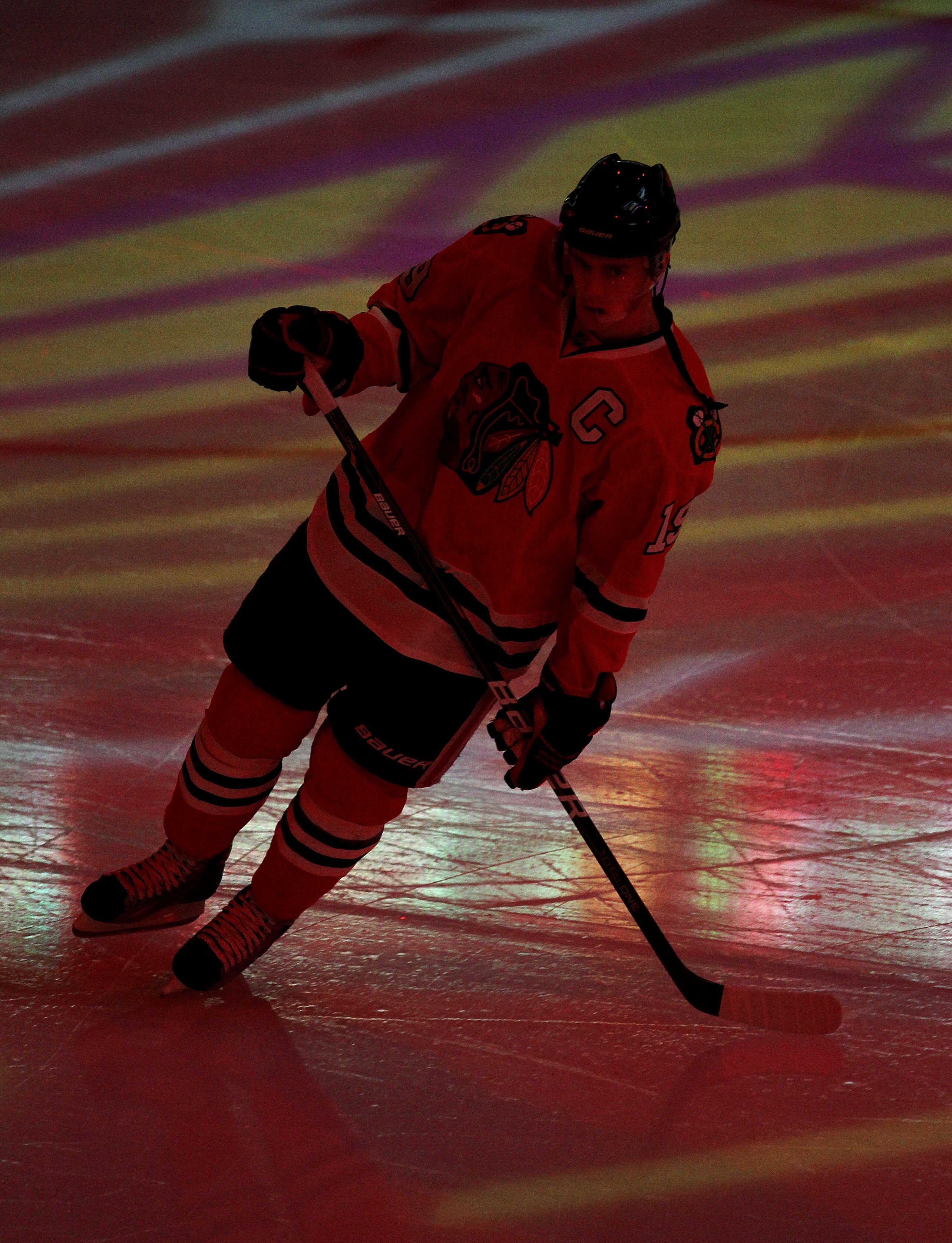 CHICAGO, IL - JANUARY 05: Jonathan Toews #19 of the Chicago Blackhawks skates during player introductions before a game against the Dallas Stars at the United Center on January 5, 2011 in Chicago, Illinois. The Stars defeated the Blackhawks 4-2.  (Photo b