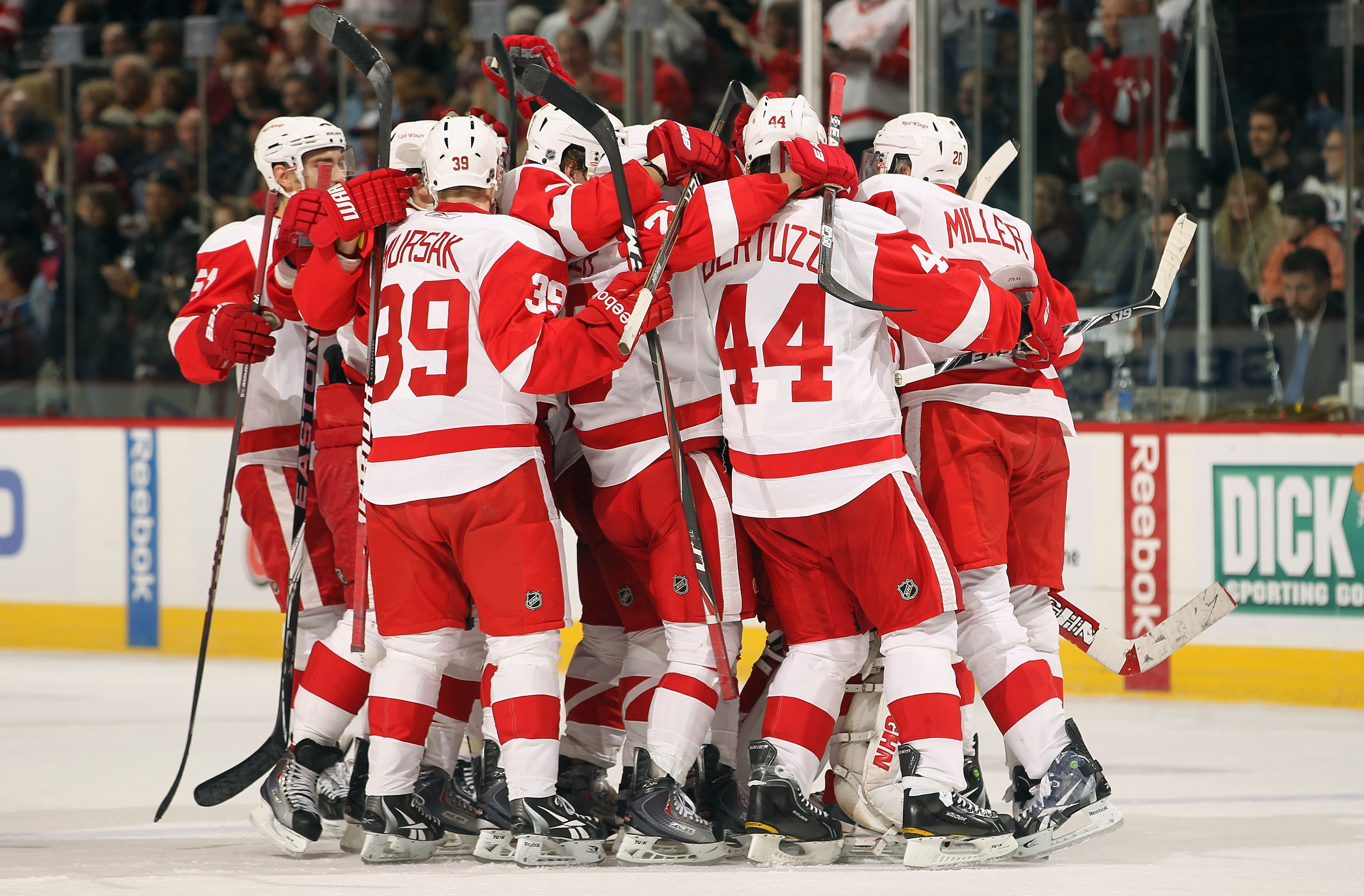 DENVER - DECEMBER 27:  The Detroit Red Wings mob their goalie Chris Osgood #30 of the Detroit Red Wings after he earned his 400th win with a victory over the Colorado Avalanche at the Pepsi Center on December 27, 2010 in Denver, Colorado. Osgood collected