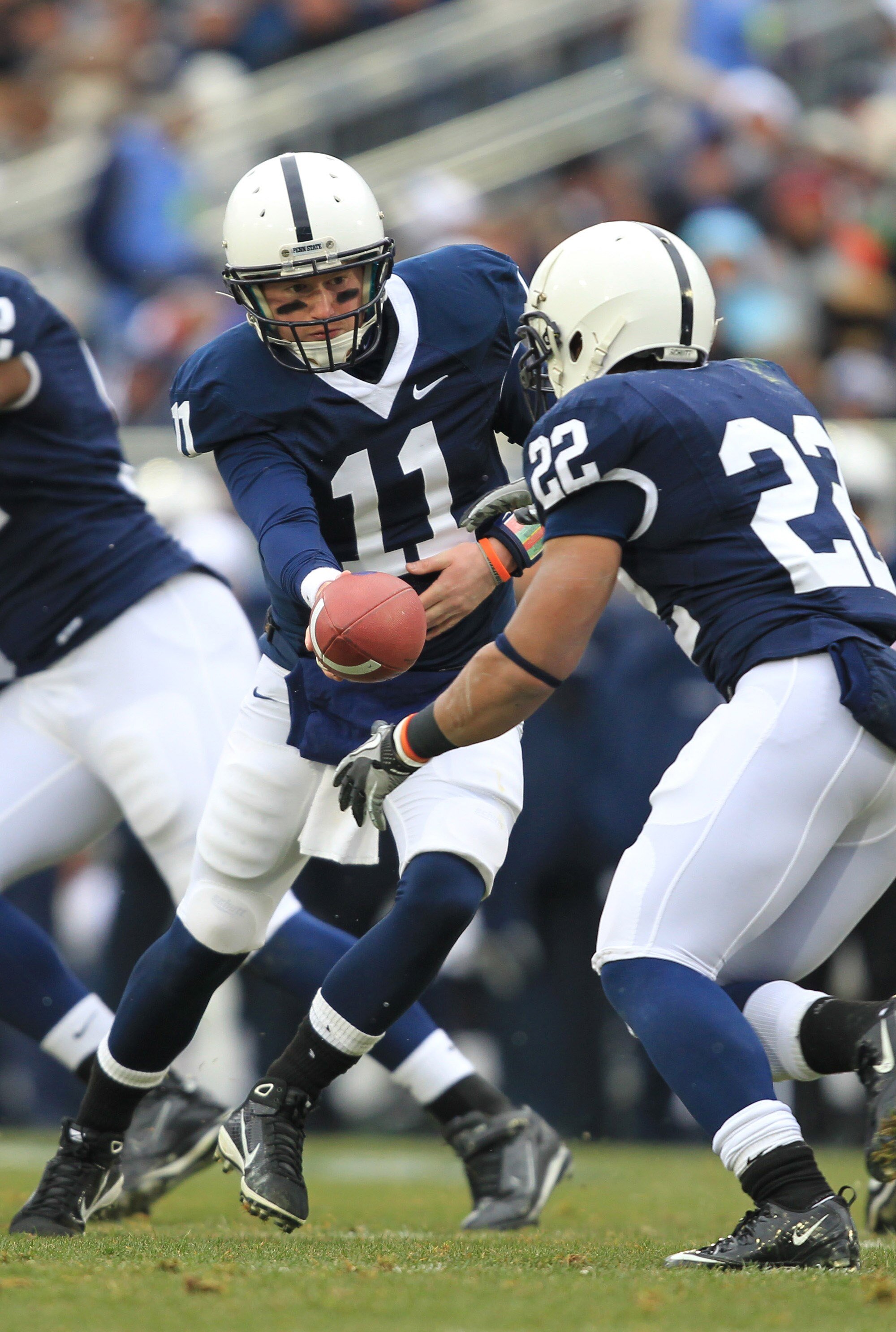 STATE COLLEGE, PA - NOVEMBER 27: Quarterback Matt McGloin #11 of the Penn State Nittany Lions hands off to running back Evan Royster #22 during a game against the Michigan State Spartans on November 27, 2010 at Beaver Stadium in State College, Pennsylvani