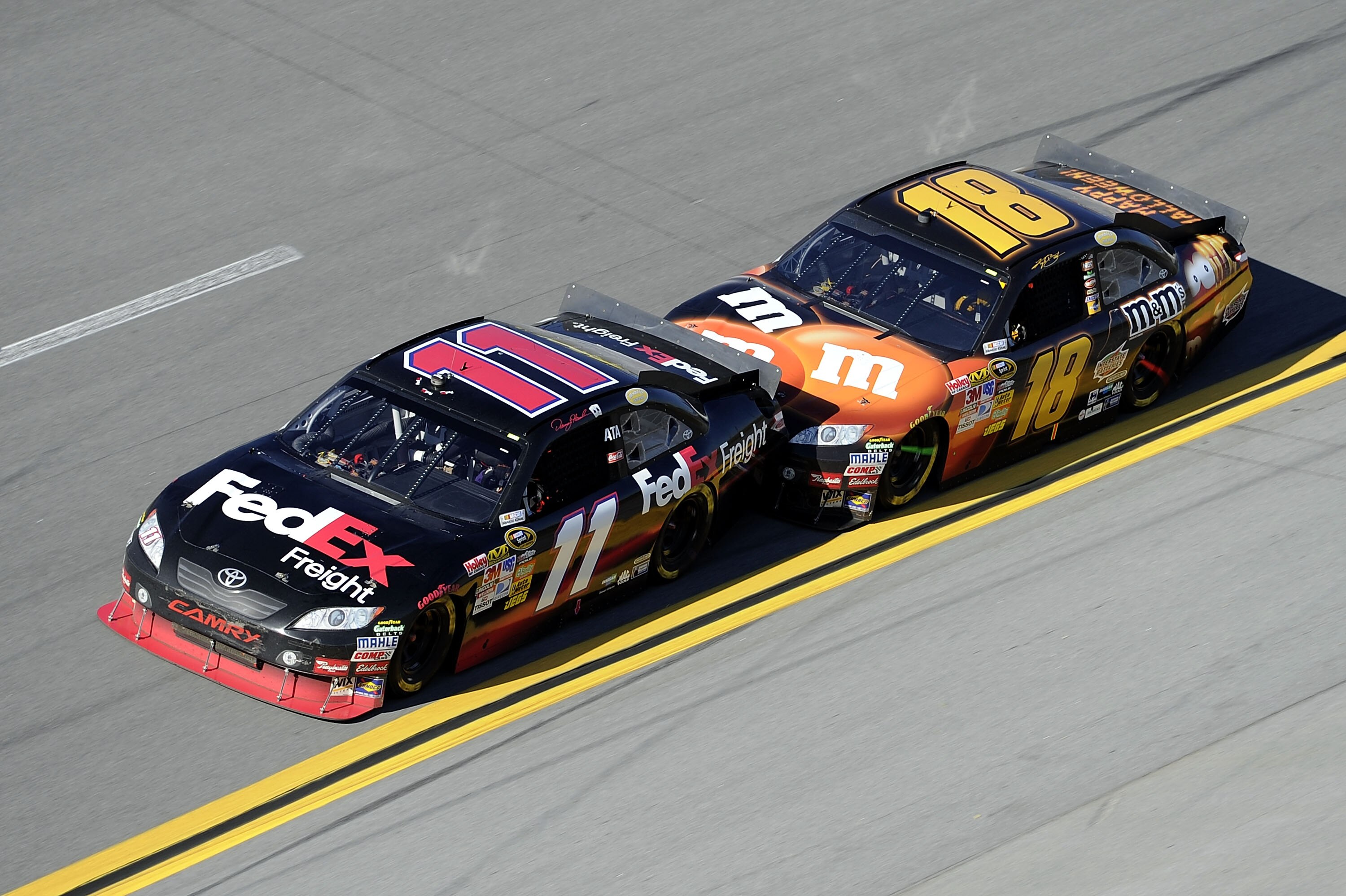 TALLADEGA, AL - OCTOBER 31:  Denny Hamlin, driver of the #11 FedEx Freight Toyota, gets bump drafted by Kyle Busch, driver of the #18 M&M's Toyota, during the NASCAR Sprint Cup Series AMP Energy Juice 500 at Talladega Superspeedway on October 31, 2010 in