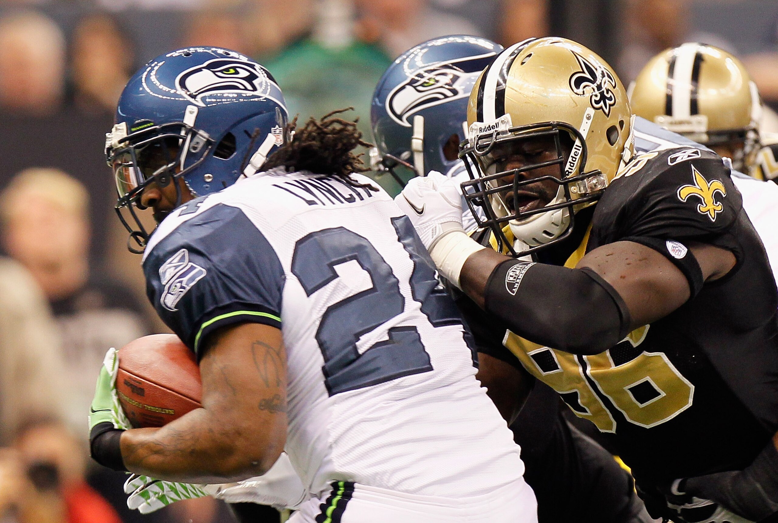 NEW ORLEANS - NOVEMBER 21:  Marshawn Lynch #24 of the Seattle Seahawks against Alex Brown #96 of the New Orleans Saints at Louisiana Superdome on November 21, 2010 in New Orleans, Louisiana.  (Photo by Kevin C. Cox/Getty Images)