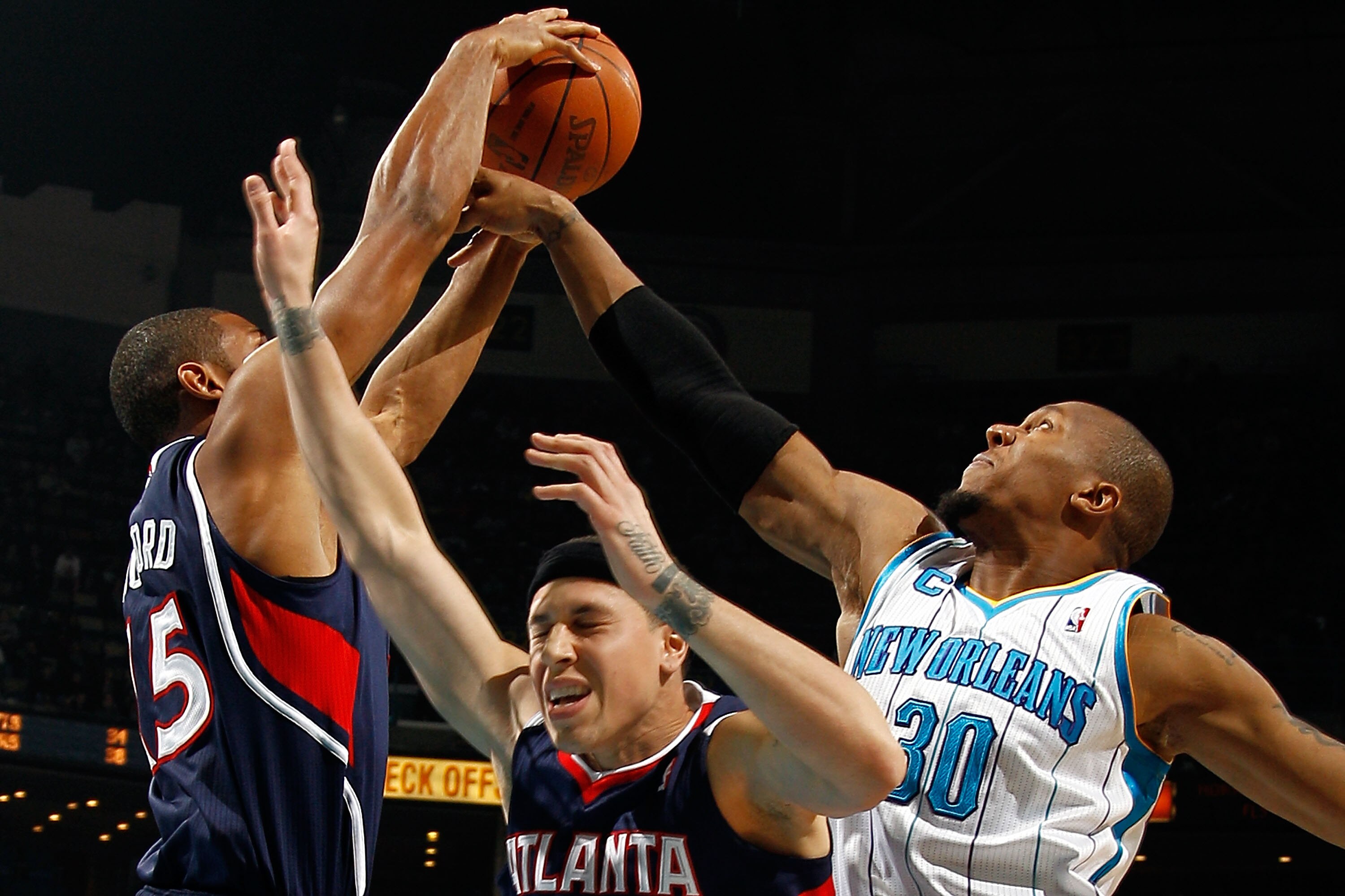 NEW ORLEANS, LA - DECEMBER 26:  Al Horford #15 of the Atlanta Hawks fights for a rebound with David West #30 of the New Orleans Hornets at the New Orleans Arena on December 26, 2010 in New Orleans, Louisiana.  The Hornets defeated the Hawks 93-86.  NOTE T