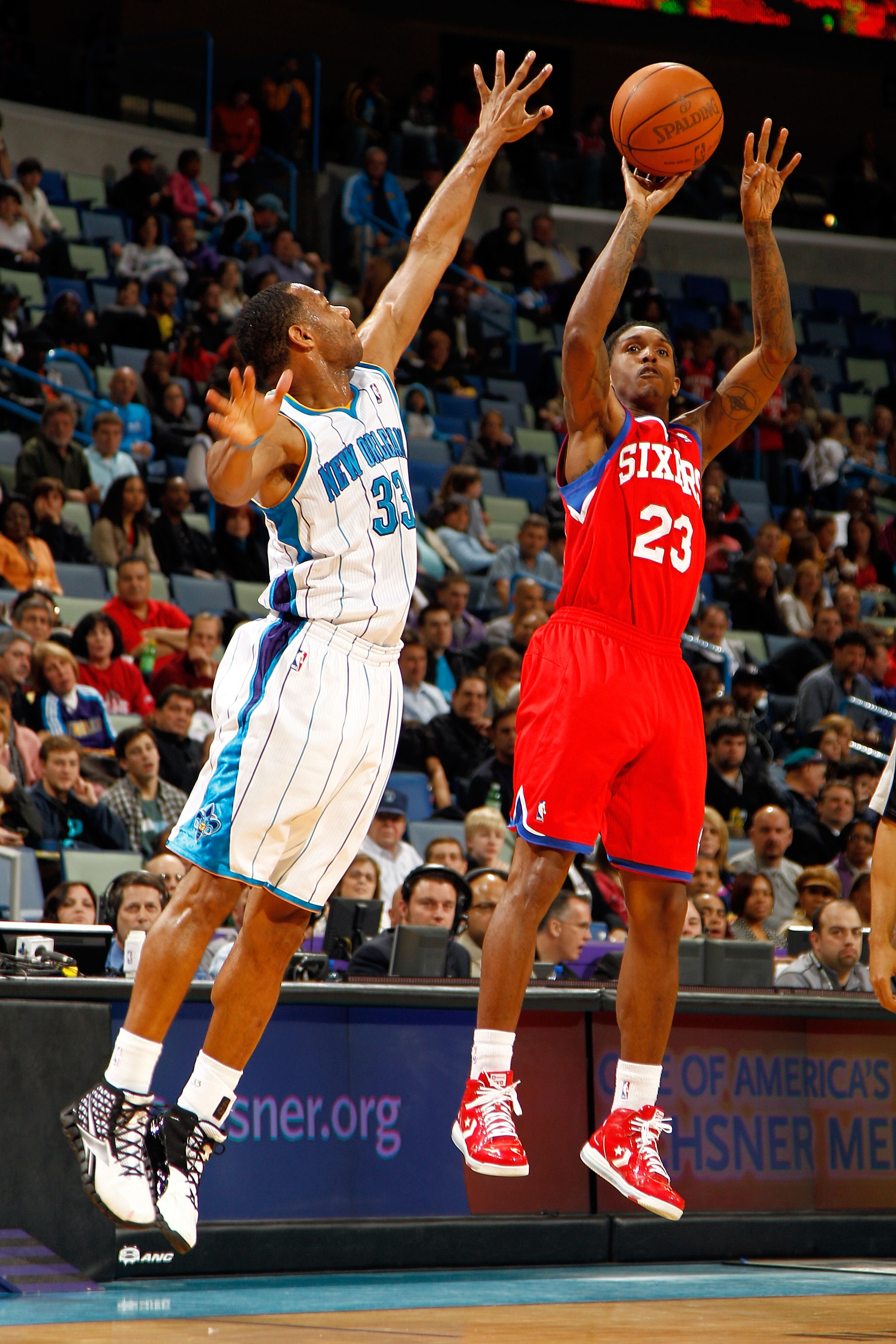 NEW ORLEANS, LA - JANUARY 03:  Lou Williams #23 of the Philadelphia 76ers shoots over Willie Green #33 of the New Orleans Hornets at New Orleans Arena on January 3, 2011 in New Orleans, Louisiana. NOTE TO USER: User expressly acknowledges and agrees that,
