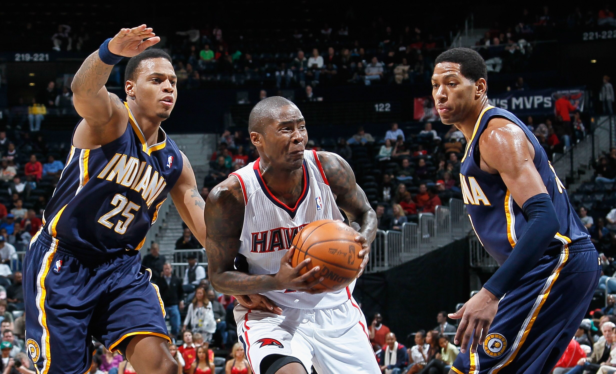 ATLANTA, GA - DECEMBER 11:  Jamal Crawford #25 of the Atlanta Hawks against Danny Granger #33 and Brandon Rush #25 of the Indiana Pacers at Philips Arena on December 11, 2010 in Atlanta, Georgia.  NOTE TO USER: User expressly acknowledges and agrees that,