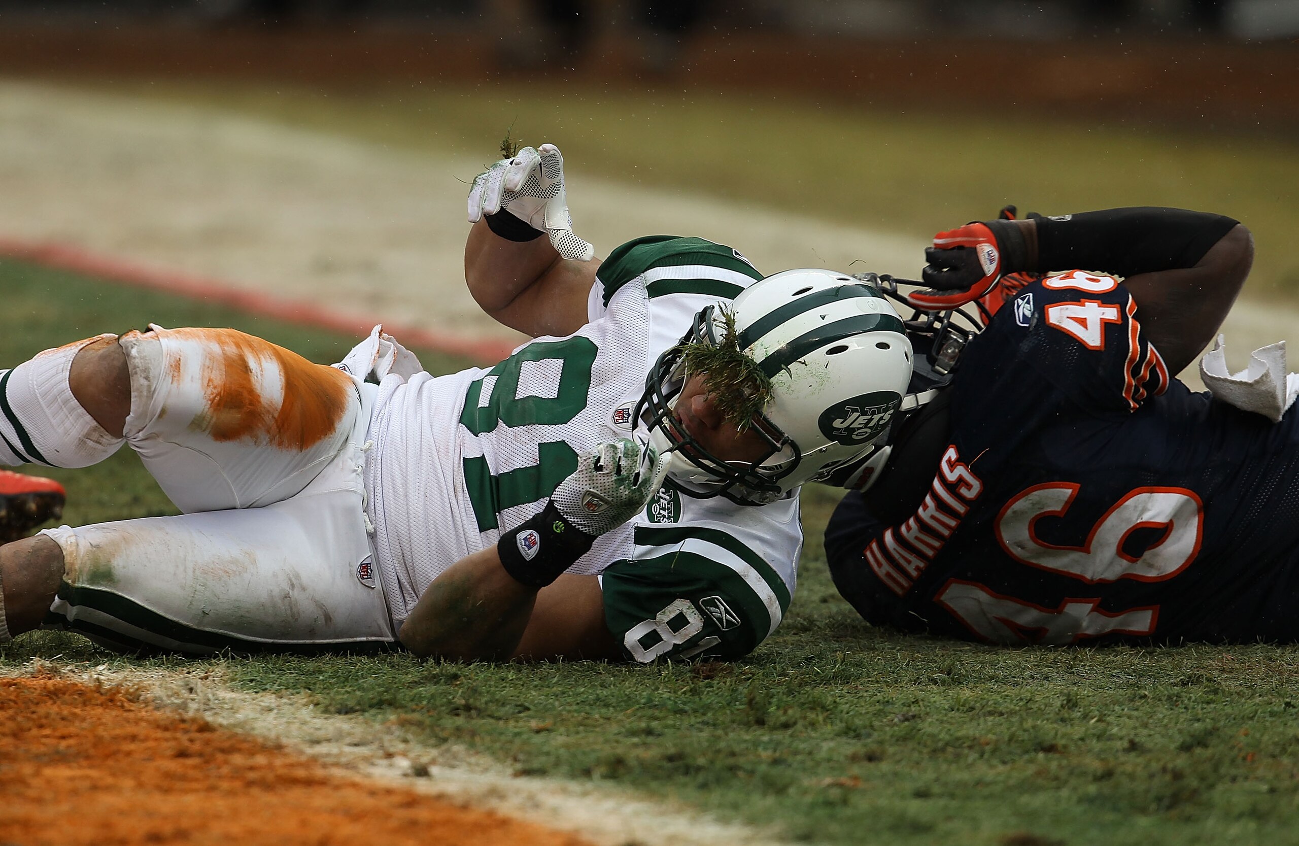 CHICAGO, IL - DECEMBER 26: Dustin Keller #81 of the New York Jets gets grass stuck to his facemask after getting hit by Chris Harris #46 of the Chicago Bears at Soldier Field on December 26, 2010 in Chicago, Illinois. The Bears defeated the Jets 38-34. (P CHICAGO, IL - DECEMBER 26: Dustin Keller #81 of the New York Jets gets grass stuck to his facemask after getting hit by Chris Harris #46 of the Chicago Bears at Soldier Field on December 26, 2010 in Chicago, Illinois. The Bears defeated the Jets 38-34. (P