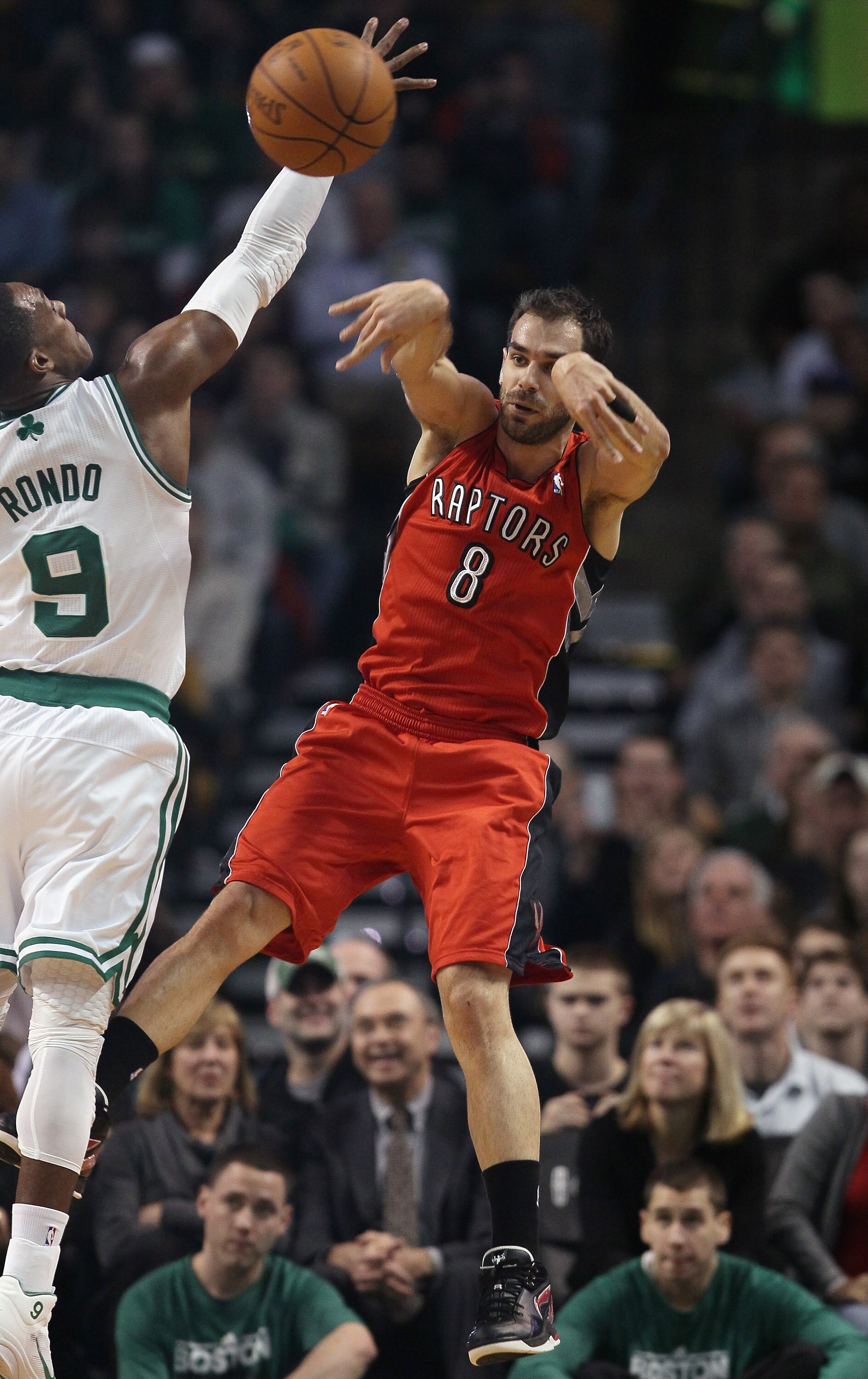 BOSTON, MA - JANUARY 07:  Jose Calderon #8 of the Toronto Raptors passes the ball as Rajon Rondo #9 of the Boston Celtics defends on January 7, 2011 at the TD Garden in Boston, Massachusetts. NOTE TO USER: User expressly acknowledges and agrees that, by d
