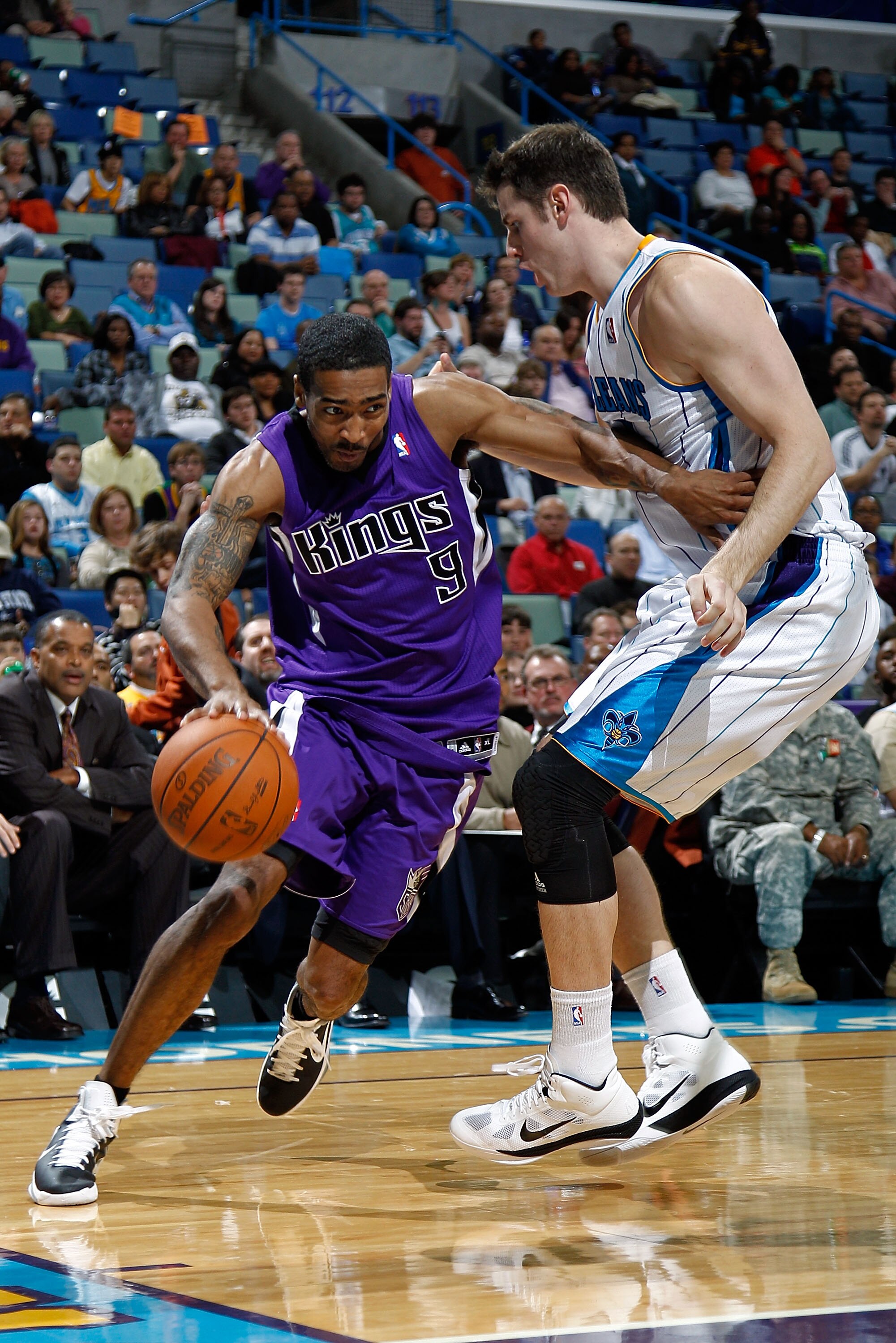 NEW ORLEANS, LA - DECEMBER 15:  Luther Head #9 of the Sacramento Kings drives the ball around Jason Smith #14 of the New Orleans Hornets  at the New Orleans Arena on December 15, 2010 in New Orleans, Louisiana.  The Hornets defeated the Kings 94-91.  NOTE