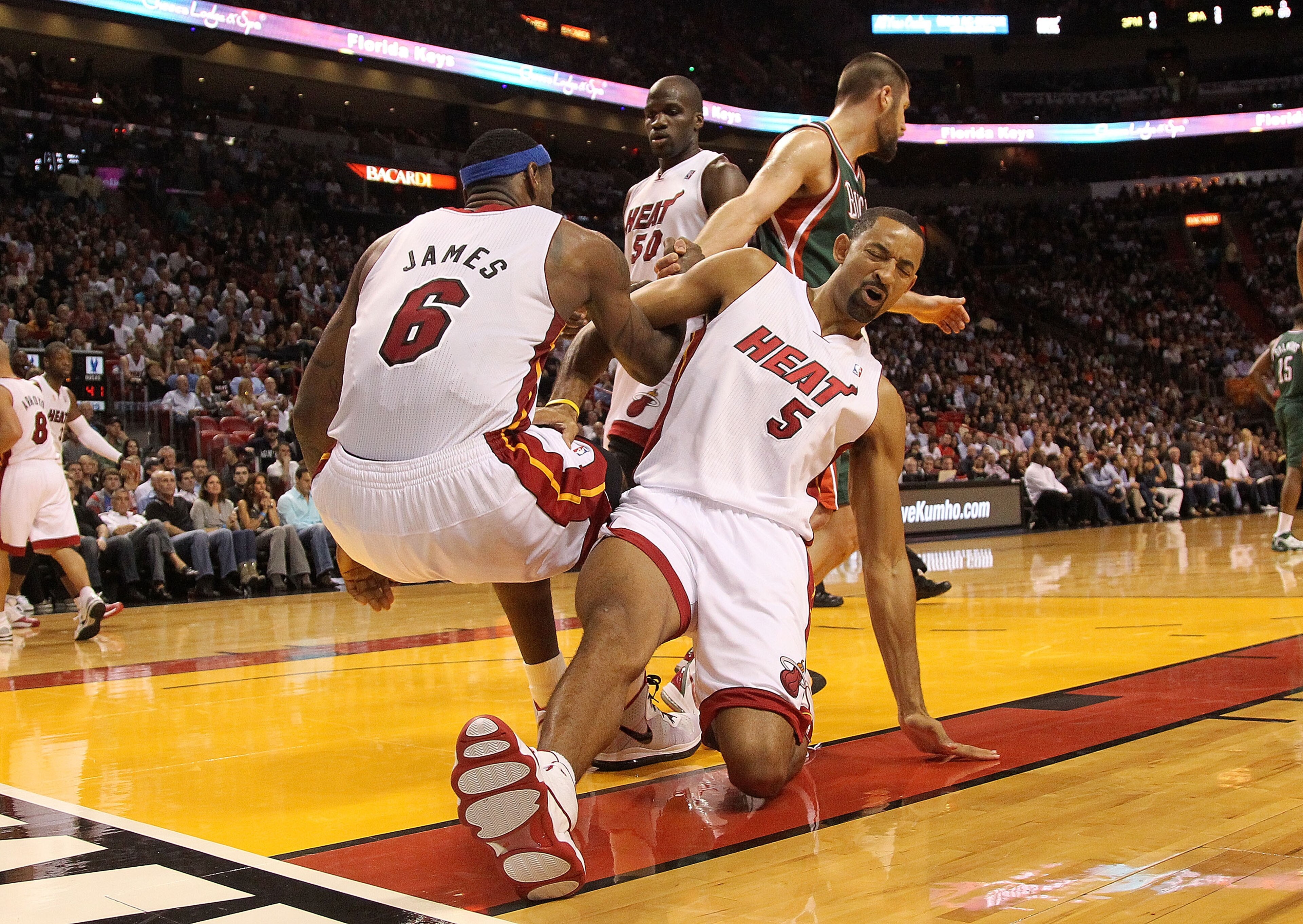 MIAMI, FL - JANUARY 04: Juwan Howard #5 of the Miami Heat slips trying to help up LeBron James #6 during a game against the Milwaukee Bucks at American Airlines Arena on January 4, 2011 in Miami, Florida. NOTE TO USER: User expressly acknowledges and agre