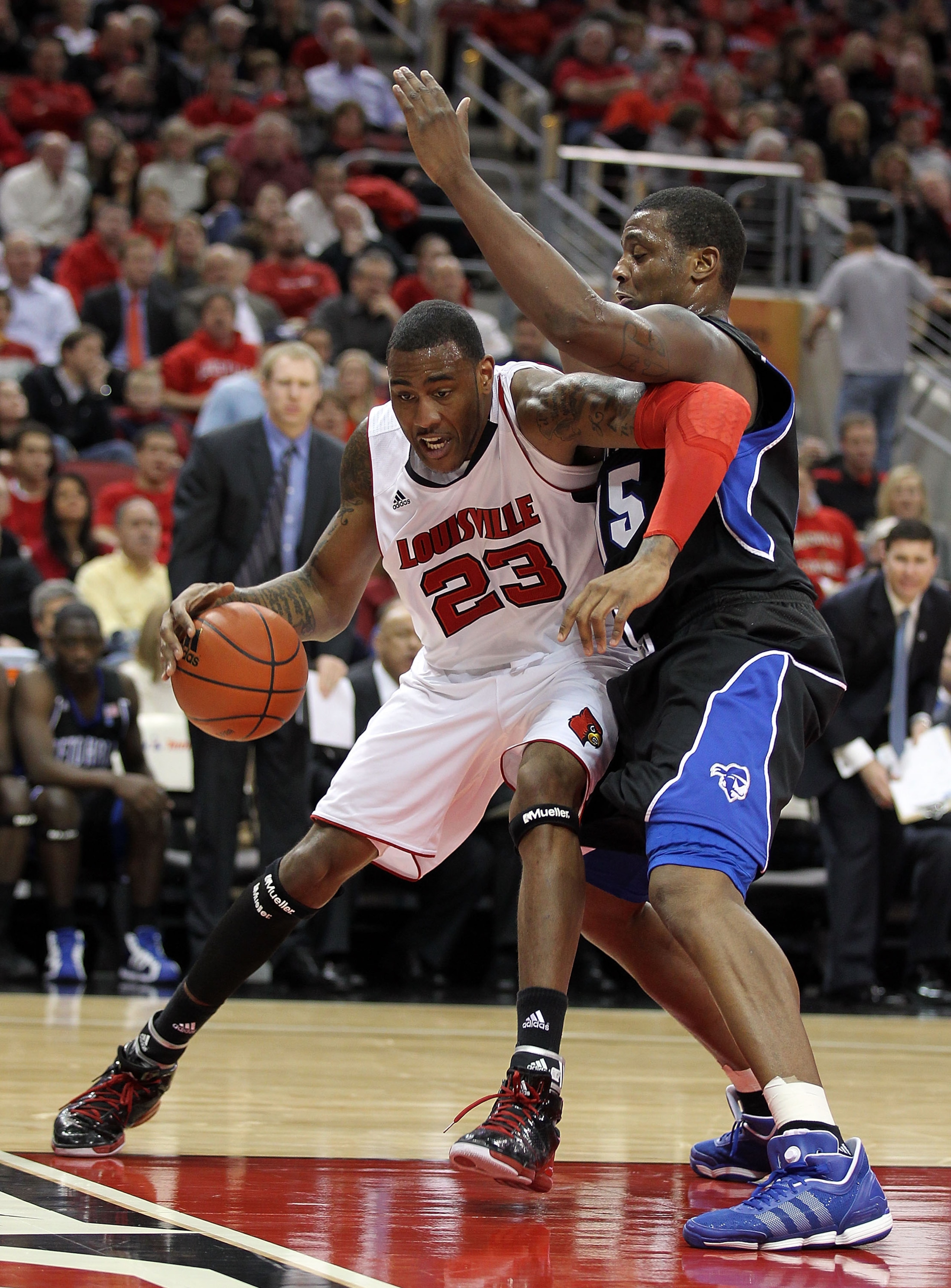 LOUISVILLE, KY - JANUARY 05: Terrence Jennings #23 of the Louisville Cardinals dribbles the ball while defended by Herb Pope #15 of the Seton Hall Pirates during the Big East Conference game at the KFC Yum! Center on January 5, 2011 in Louisville, Kentuck