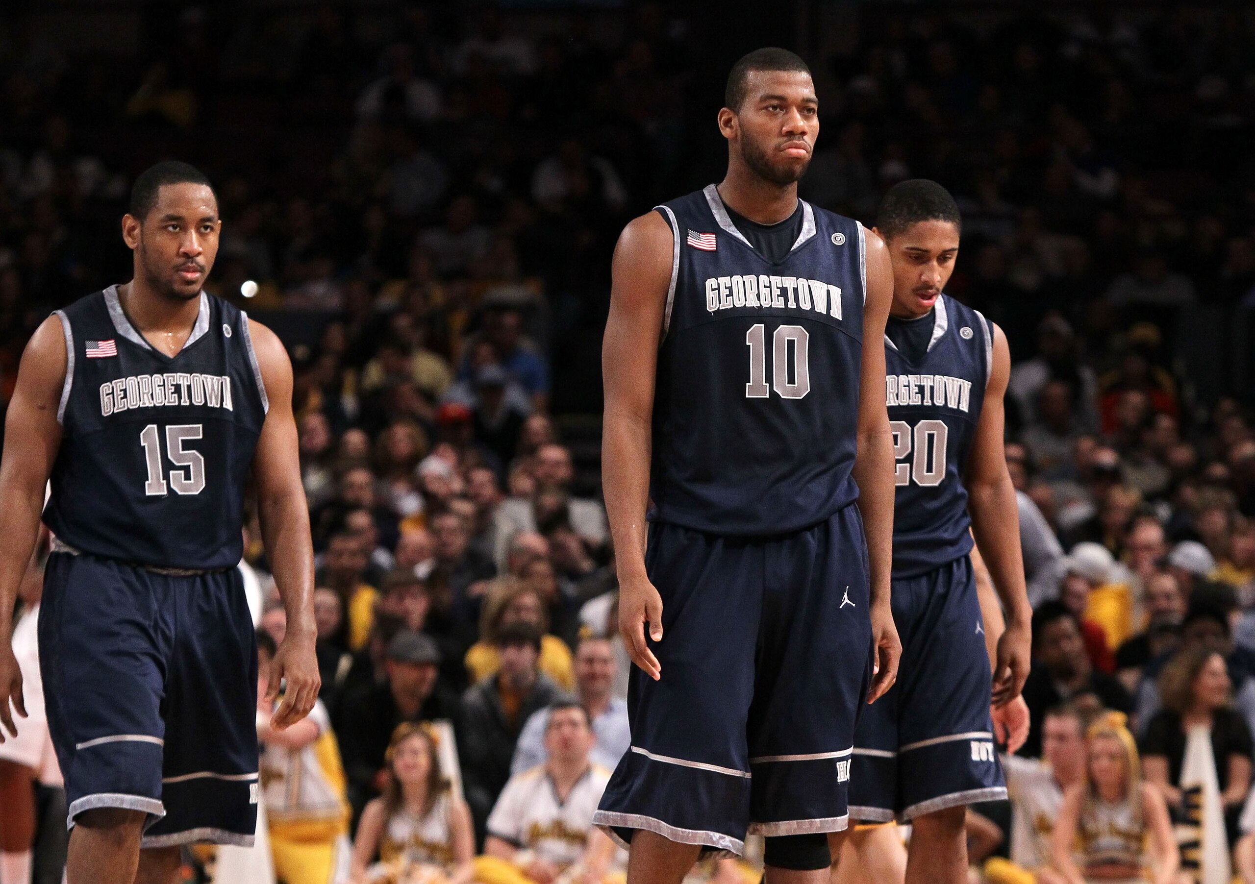 NEW YORK - MARCH 13: Austin Freeman #15, Greg Monroe #10 and Jerrelle Benimon #20 of the Georgetown Hoyas walk to the bench after a play against the West Virginia Mountaineers during the championship of the 2010 NCAA Big East Tournament at Madison Square