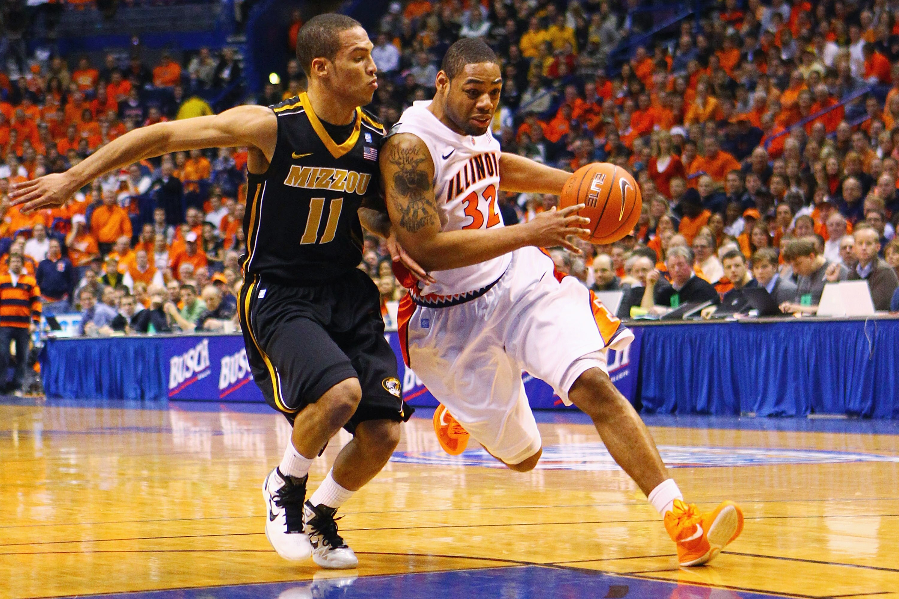 ST. LOUIS, MO - DECEMBER 22: Demetri McCamey #32 of the Illinois Fighting Illini drives to the basket against Michael Dixon #11 of the Missouri Tigers during the Busch Braggin' Rights game at the Scottrade Center on December 22, 2010 in St. Louis, Missour