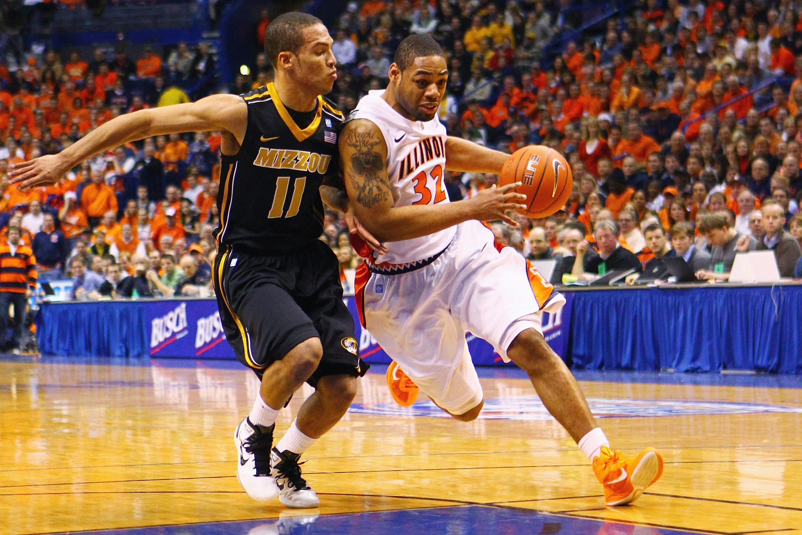 ST. LOUIS, MO - DECEMBER 22: Demetri McCamey #32 of the Illinois Fighting Illini drives to the basket against Michael Dixon #11 of the Missouri Tigers during the Busch Braggin' Rights game at the Scottrade Center on December 22, 2010 in St. Louis, Missour