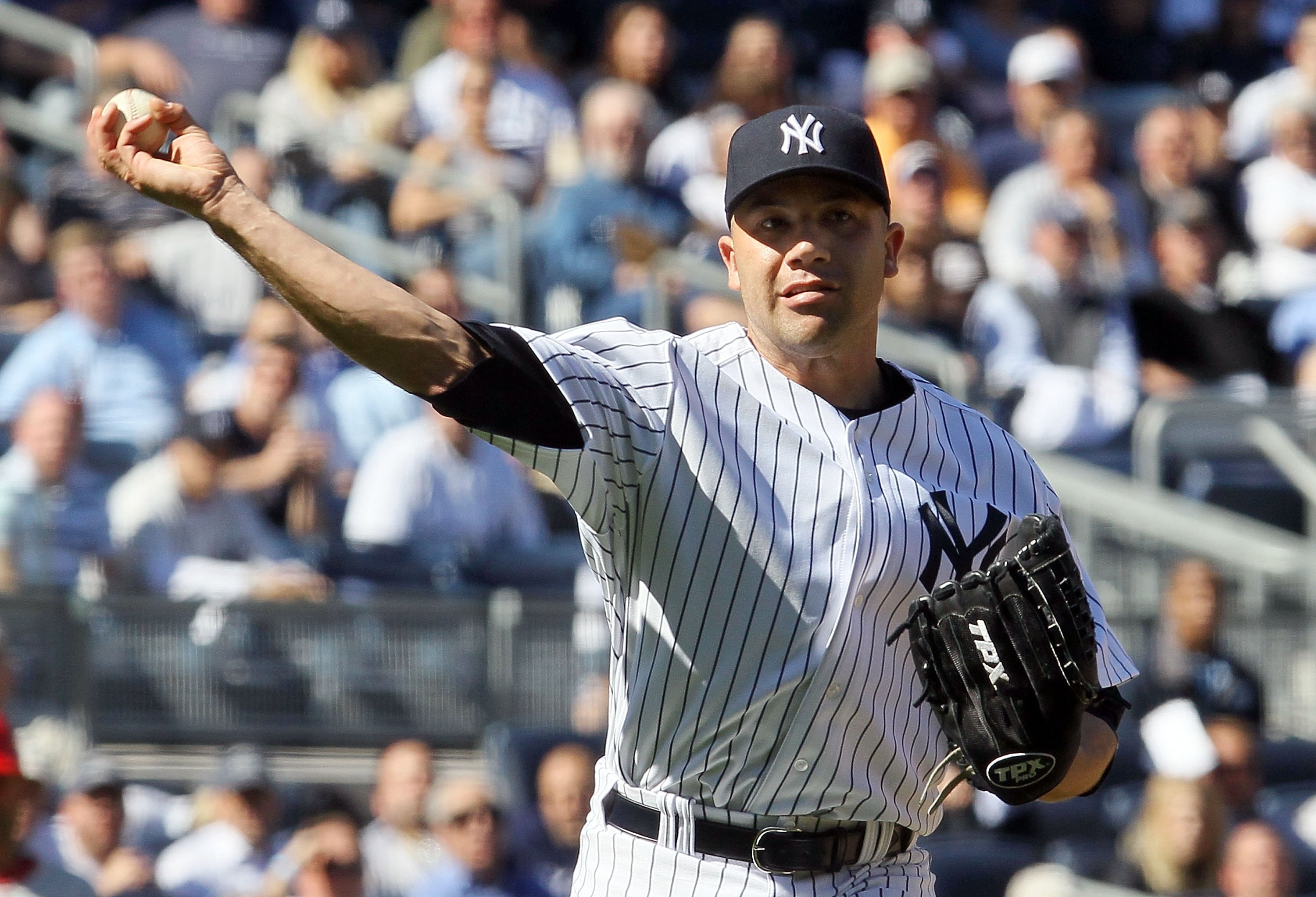 NEW YORK - APRIL 14:  Alfredo Aceves #91 of the New York Yankees throws to first base against the Los Angeles Angels of Anaheim on April 14, 2010 at Yankee Stadium in the Bronx borough of New York City.  (Photo by Jim McIsaac/Getty Images)