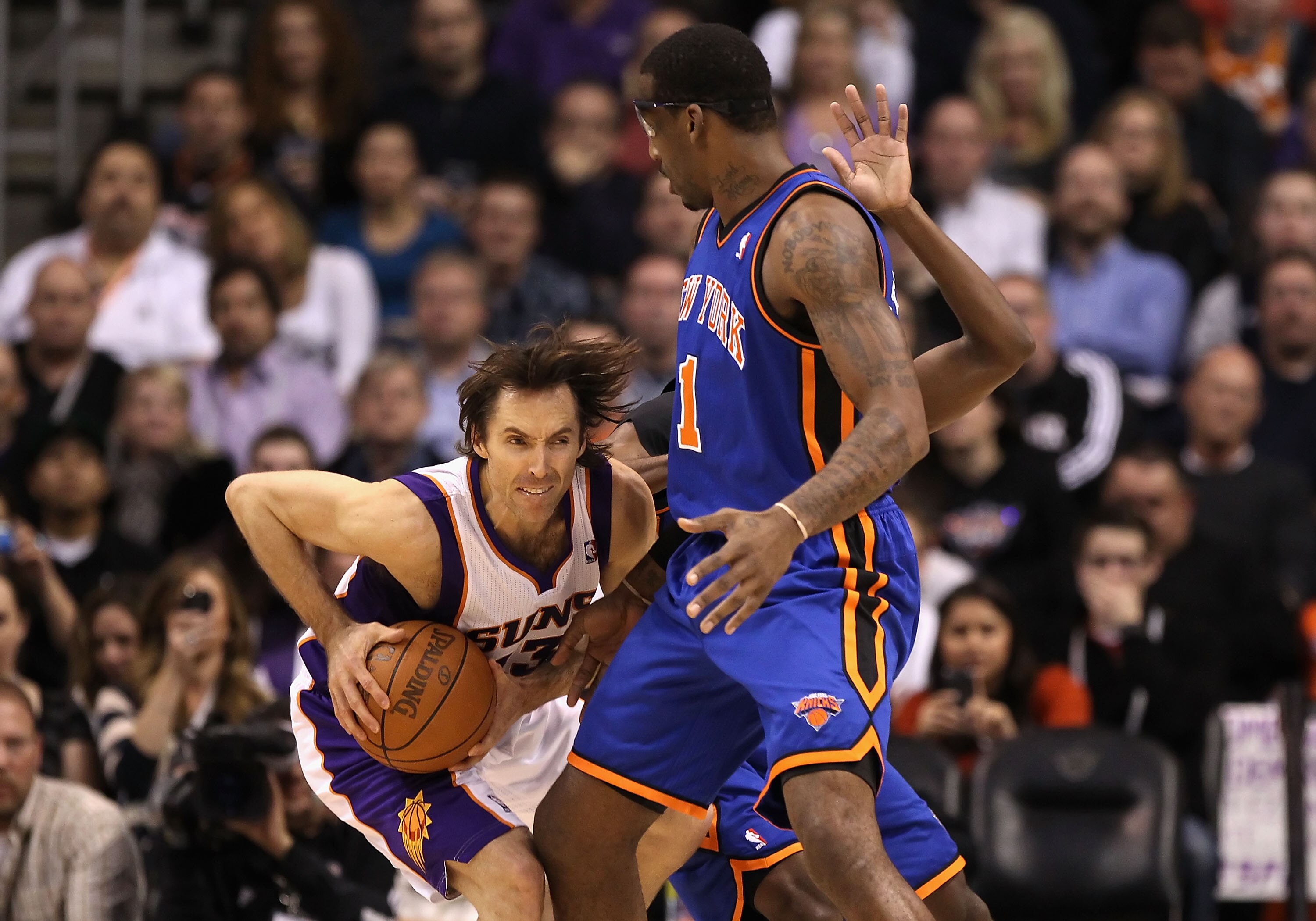 PHOENIX - JANUARY 07:  Steve Nash #13 of the Phoenix Suns handles the ball under pressure from  Amar'e Stoudemire #1 of the New York Knicks during the NBA game at US Airways Center on January 7, 2011 in Phoenix, Arizona.  NOTE TO USER: User expressly ackn