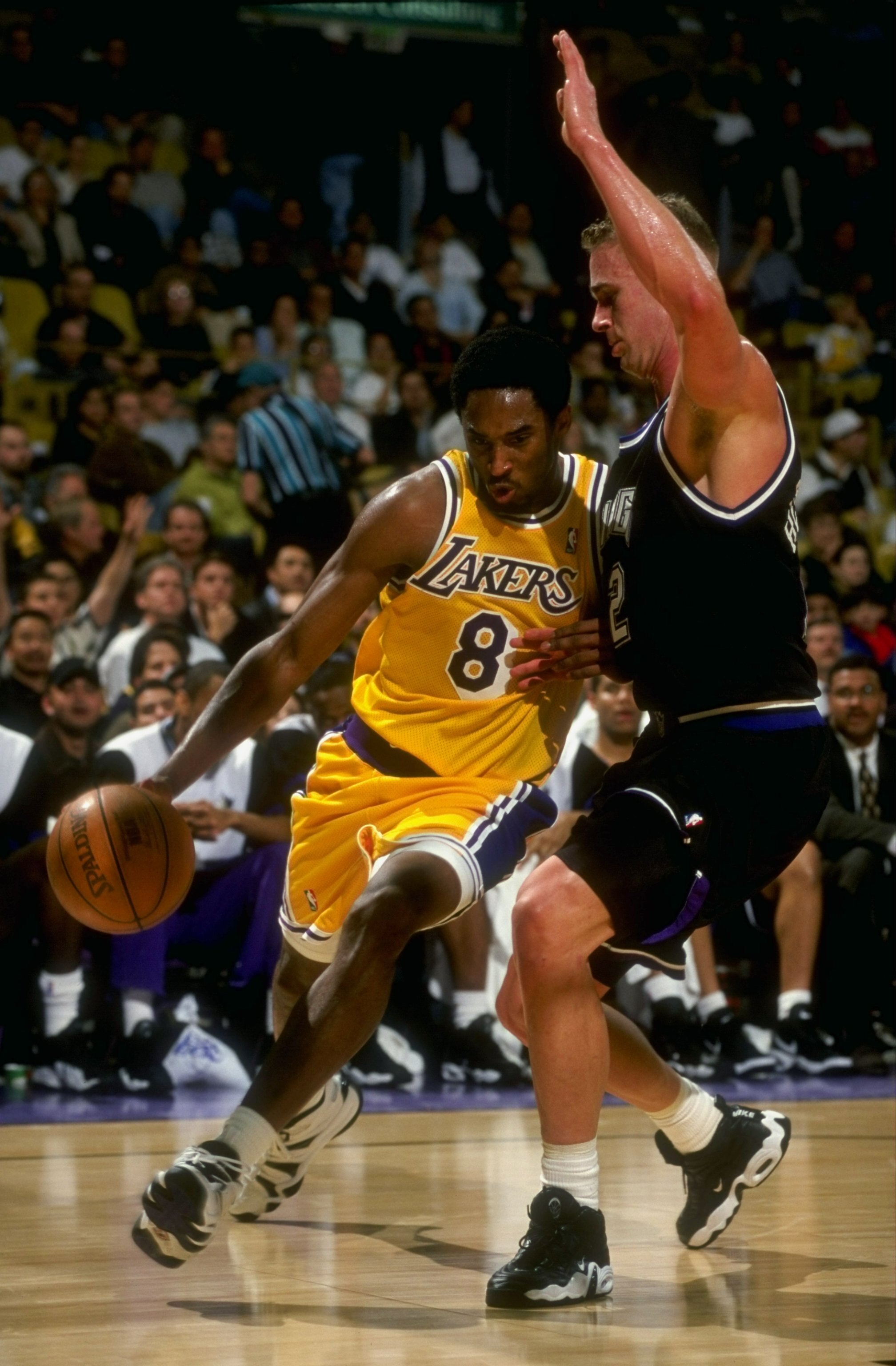 25 Mar 1998:  Guard Kobe Bryant of the Los Angeles Lakers in action against forward Mark Hendrickson of the Sacramento Kings during a game at the Great Western Forum in Inglewood, California.  The Lakers defeated the Kings 114-91. Mandatory Credit: Vincen
