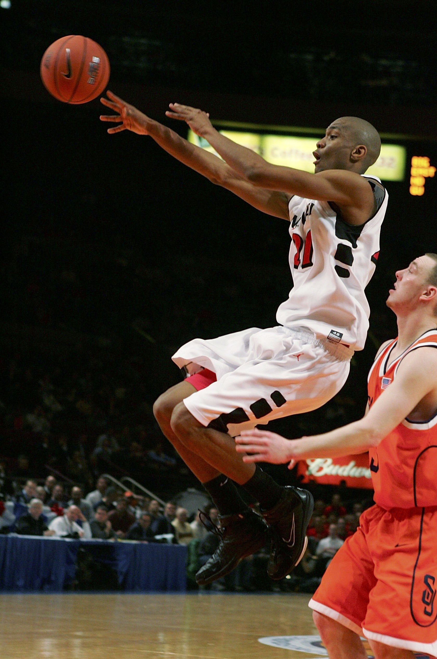 NEW YORK - MARCH 08:  James White #21 of the Cincinnati Bearcats dishes the ball off in front of Gerry McNamara #3 of the Syracuse Orangemen during the first round of the Big East Men's Basketball Championships at Madison Square Garden on March 8, 2006 in