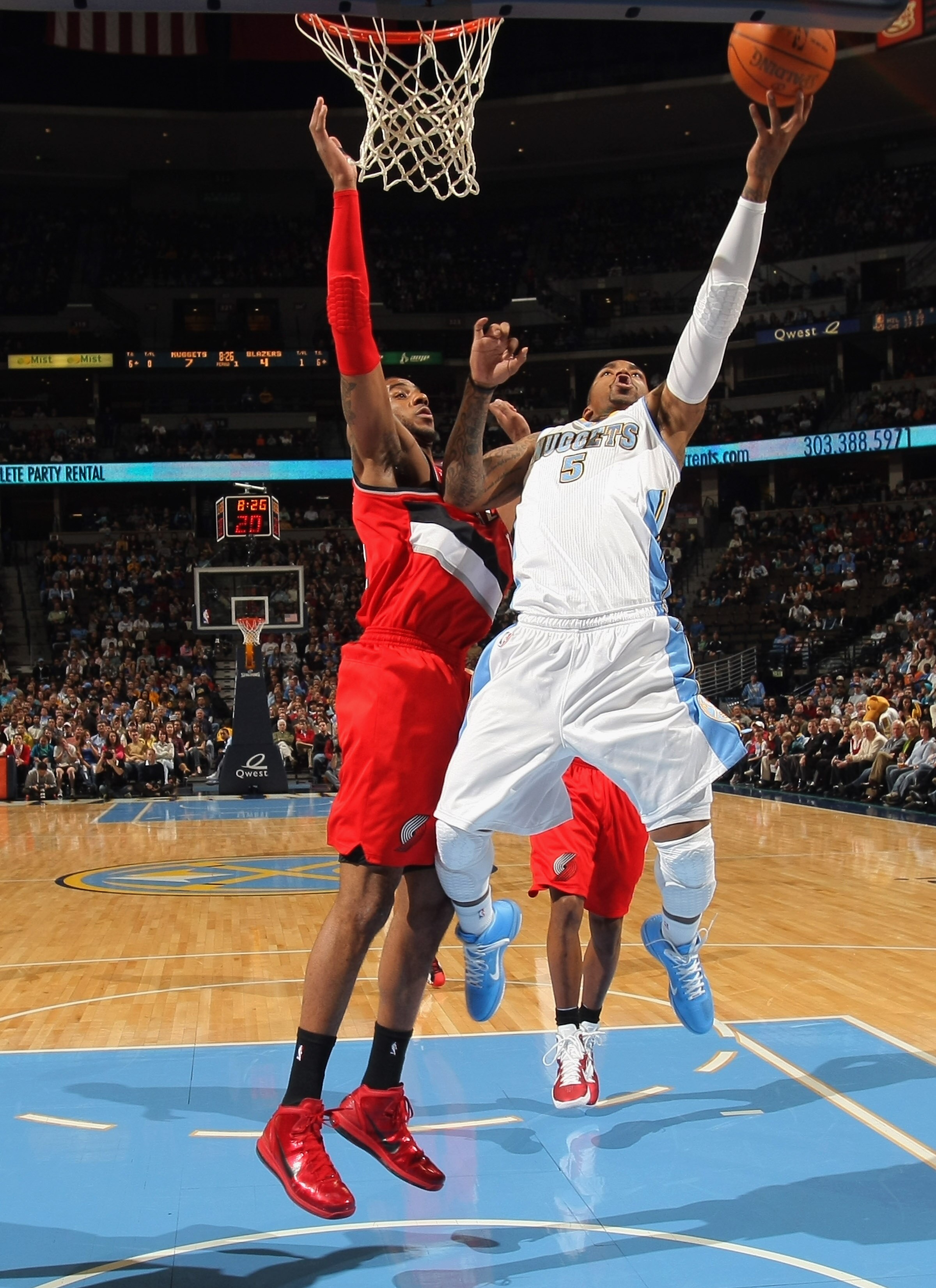 DENVER - DECEMBER 28:  J.R. Smith #5 of the Denver Nuggets takes a shot against the defense of LaMarcus Aldridge #12 of the Portland Trail Blazers at Pepsi Center on December 28, 2010 in Denver, Colorado. The Nuggets defeated the Blazers 95-77. NOTE TO US