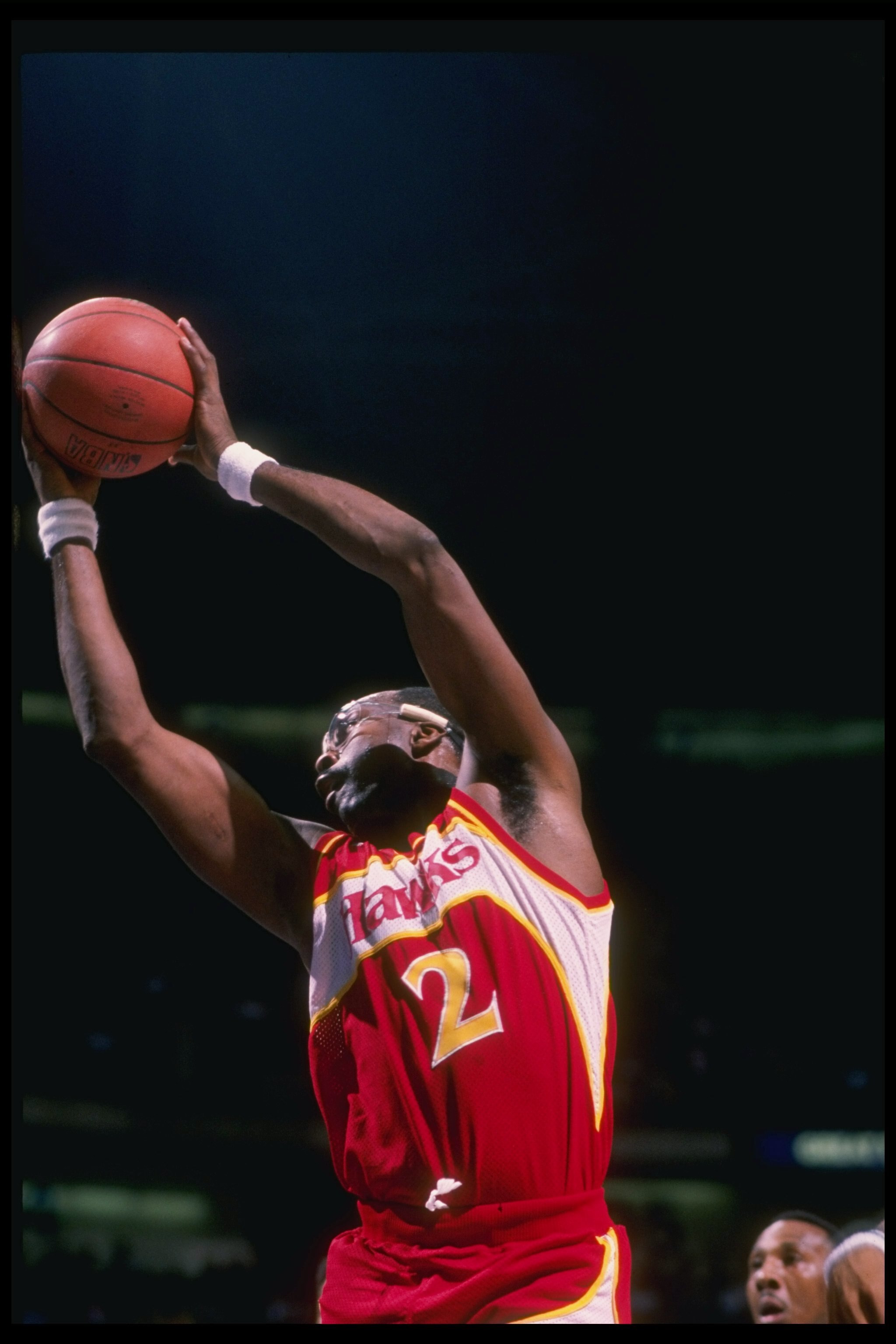 Center Moses Malone of the Atlanta Hawks jumps to the basket during a game.