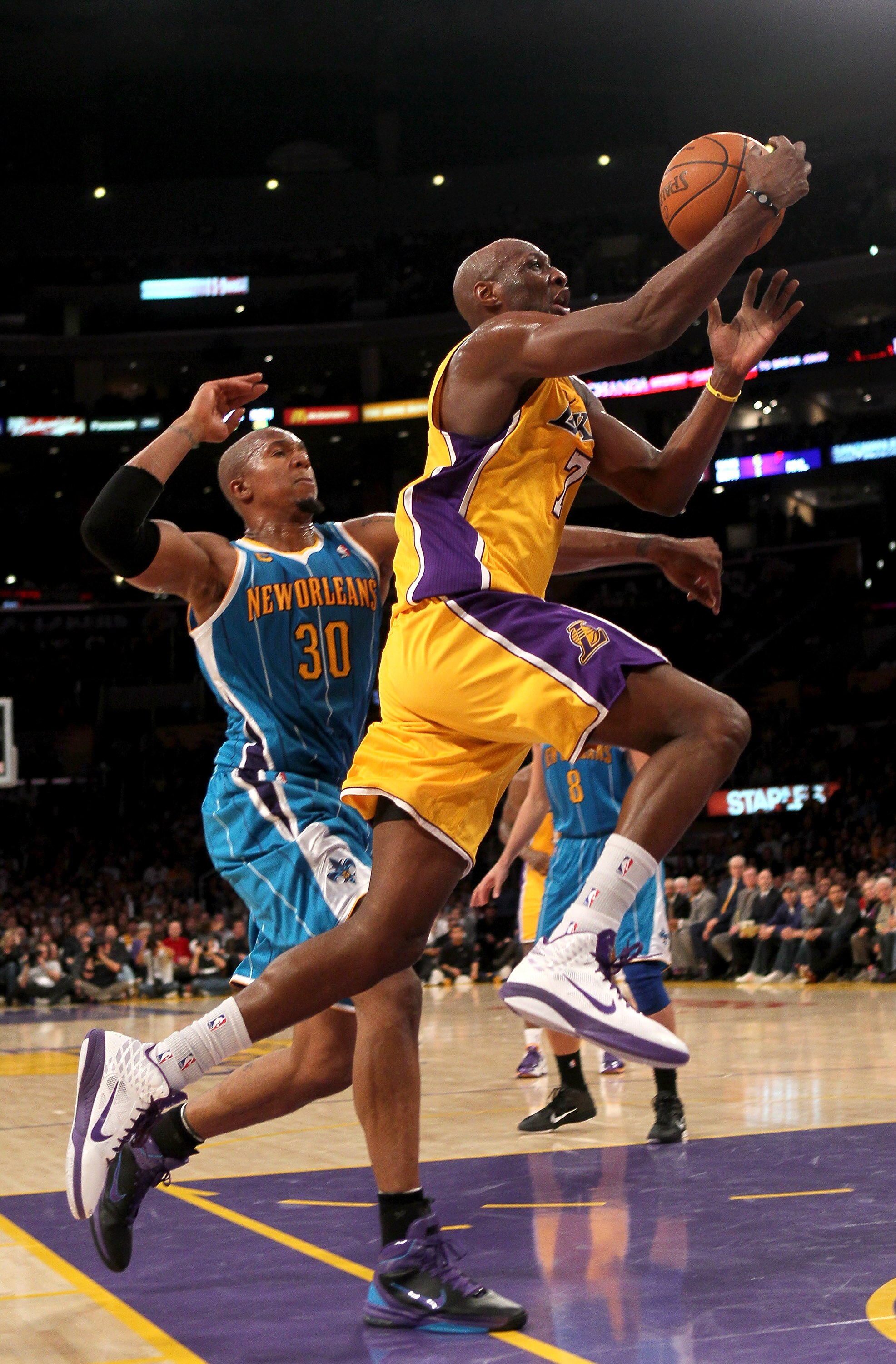 LOS ANGELES, CA - JANUARY 07:  Lamar Odom #7 of the Los Angeles Lakers goes up for a shot past David West #30 of the New Orleans Hornets at Staples Center on January 7, 2011 in Los Angeles, California.  The Lakers won 101-97.  NOTE TO USER: User expressly
