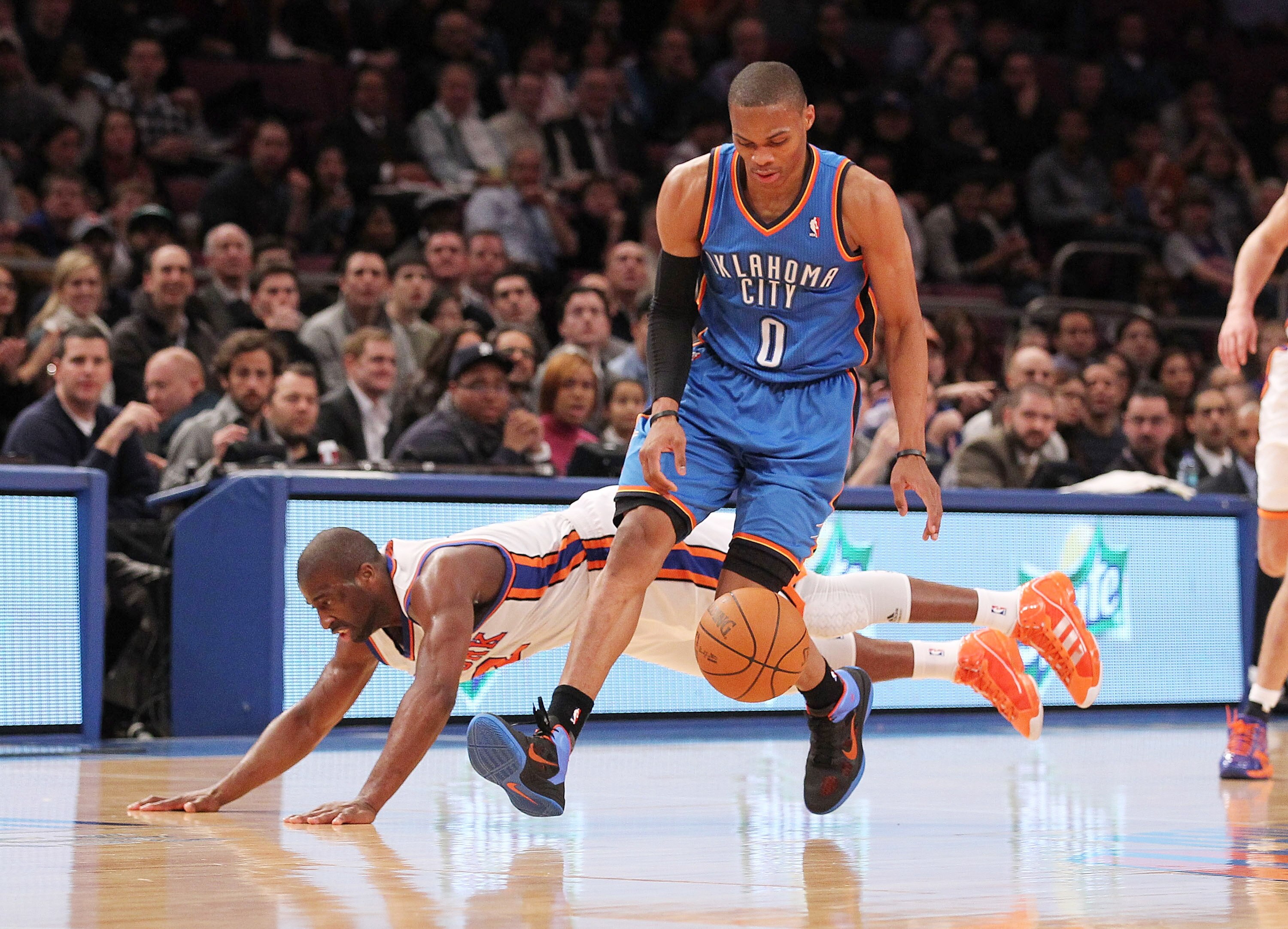 NEW YORK, NY - DECEMBER 22:  Raymond Felton #2 of the New York Knicks collides with Russell Westbrook #0 of the Oklahoma City Thunder at Madison Square Garden on December 22, 2010 in New York City.   NOTE TO USER: User expressly acknowledges and agrees th