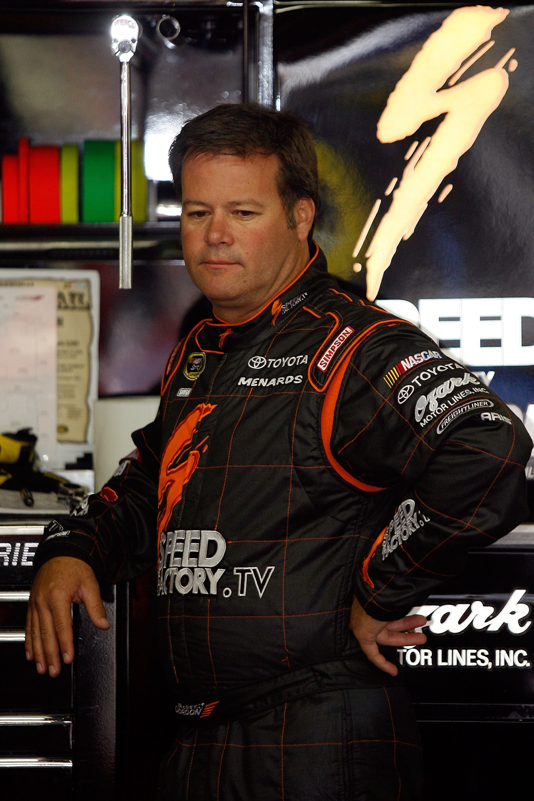 LOUDON, NH - SEPTEMBER 18:  Robby Gordon, driver of the #7 SpeedFactory.TV Toyota, looks on in the garage during practice for the NASCAR Sprint Cup Series Sylvania 300 at New Hampshire Motor Speedway on September 18, 2010 in Loudon, New Hampshire.  (Photo